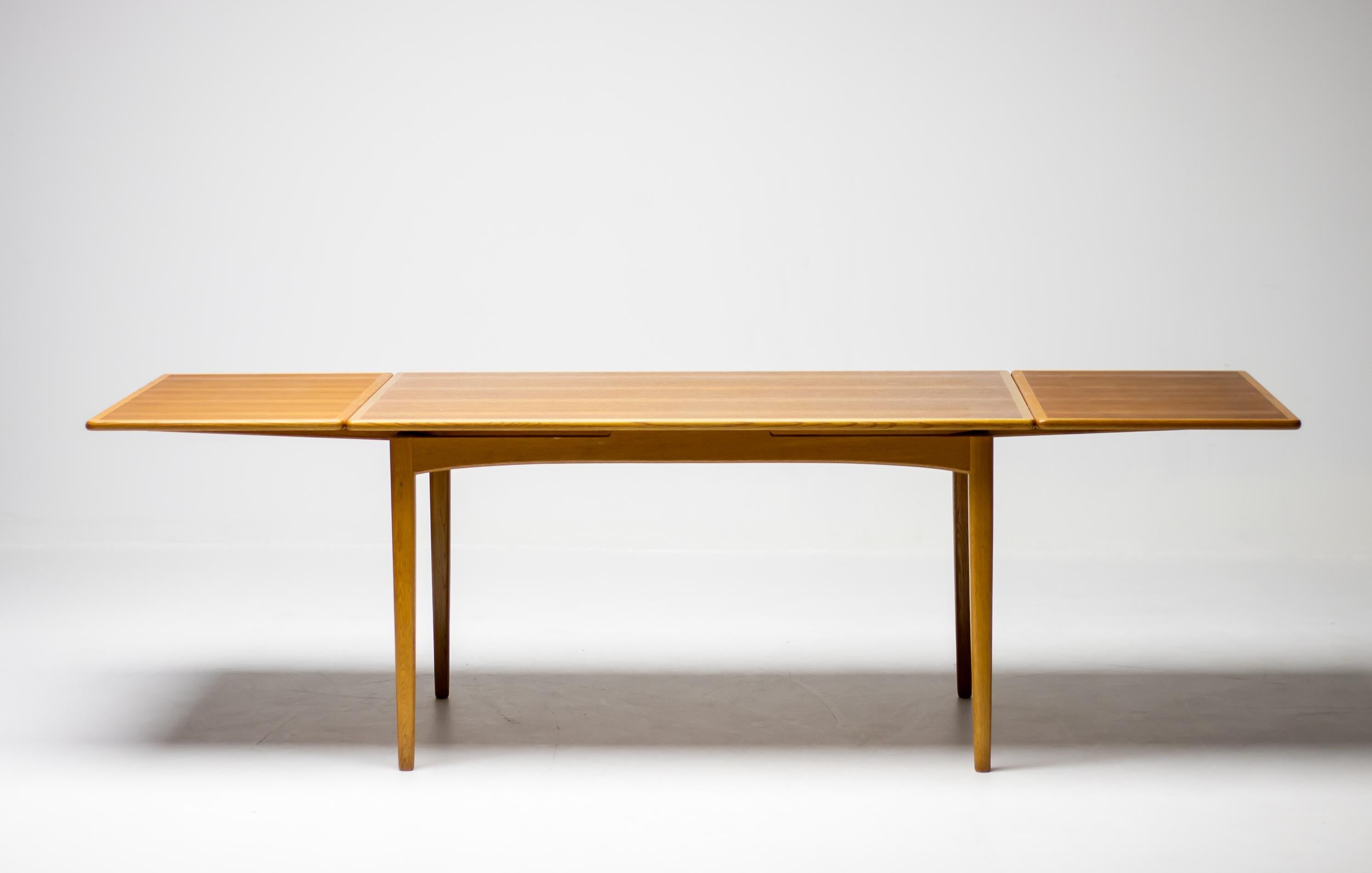 This extendable dining table designed by Yngvar Sandström for Nordiska Kompaniet, Sweden is executed in oak with a teak top with oak edges. The rectangular tabletop has two additional leaves in order to expand the table from 137 cm to 244 cm. The