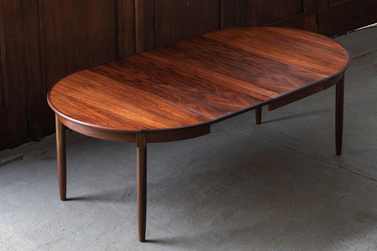 This extendable dining table was designed and produced in Denmark in the 1960’s. It can be put as a round table, seating 4 people or you can extend it with the two extra leaves up to 220 cm, easily seating a group of 8 people. The solid rosewood