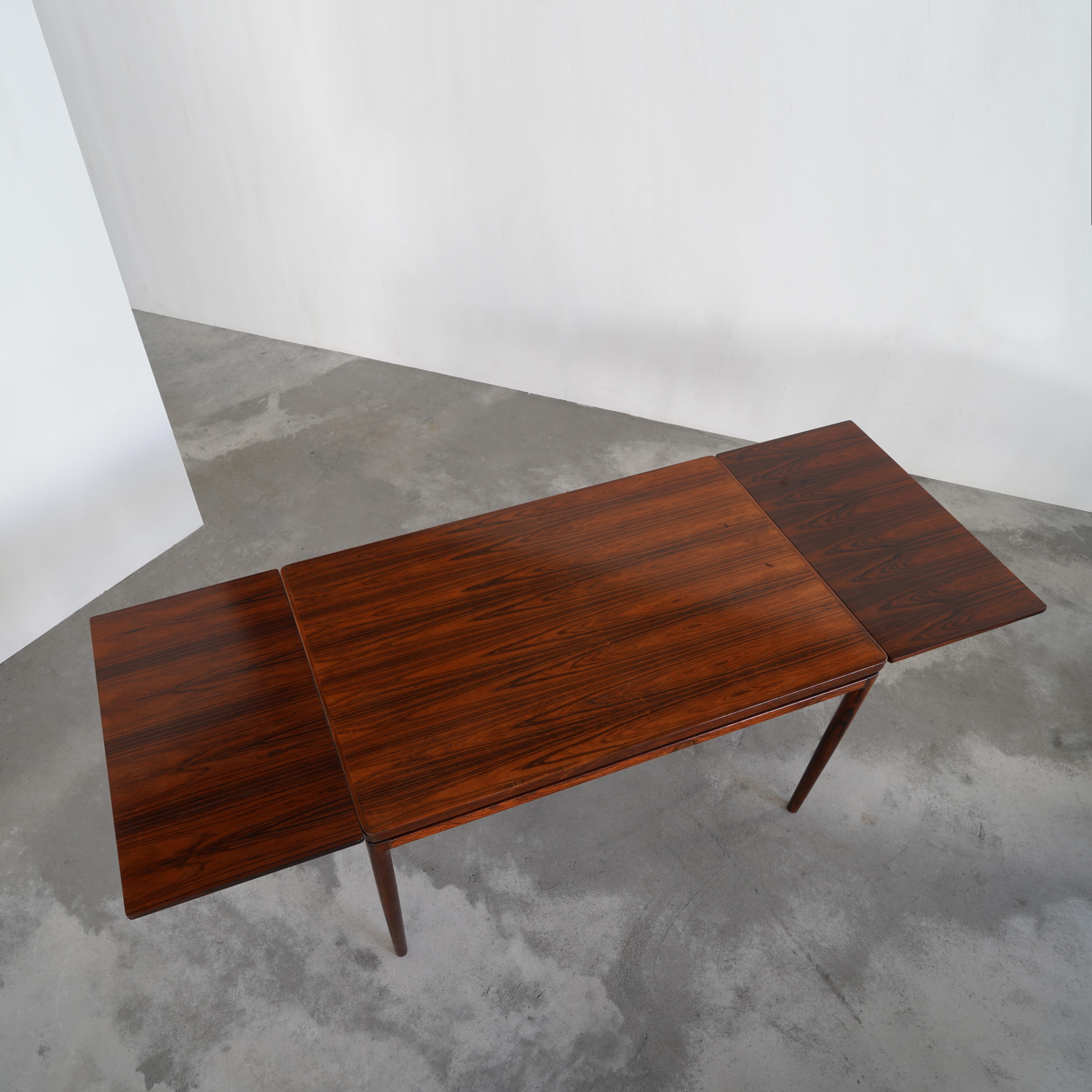 A striking dining table designed by Johannes Andersen for Christian Linneberg Møbelfabrik. 1960’s.

 The overall design is pretty straightforward, but the expressive grain of the rosewood and elegant details like the slightly tapered legs make it
