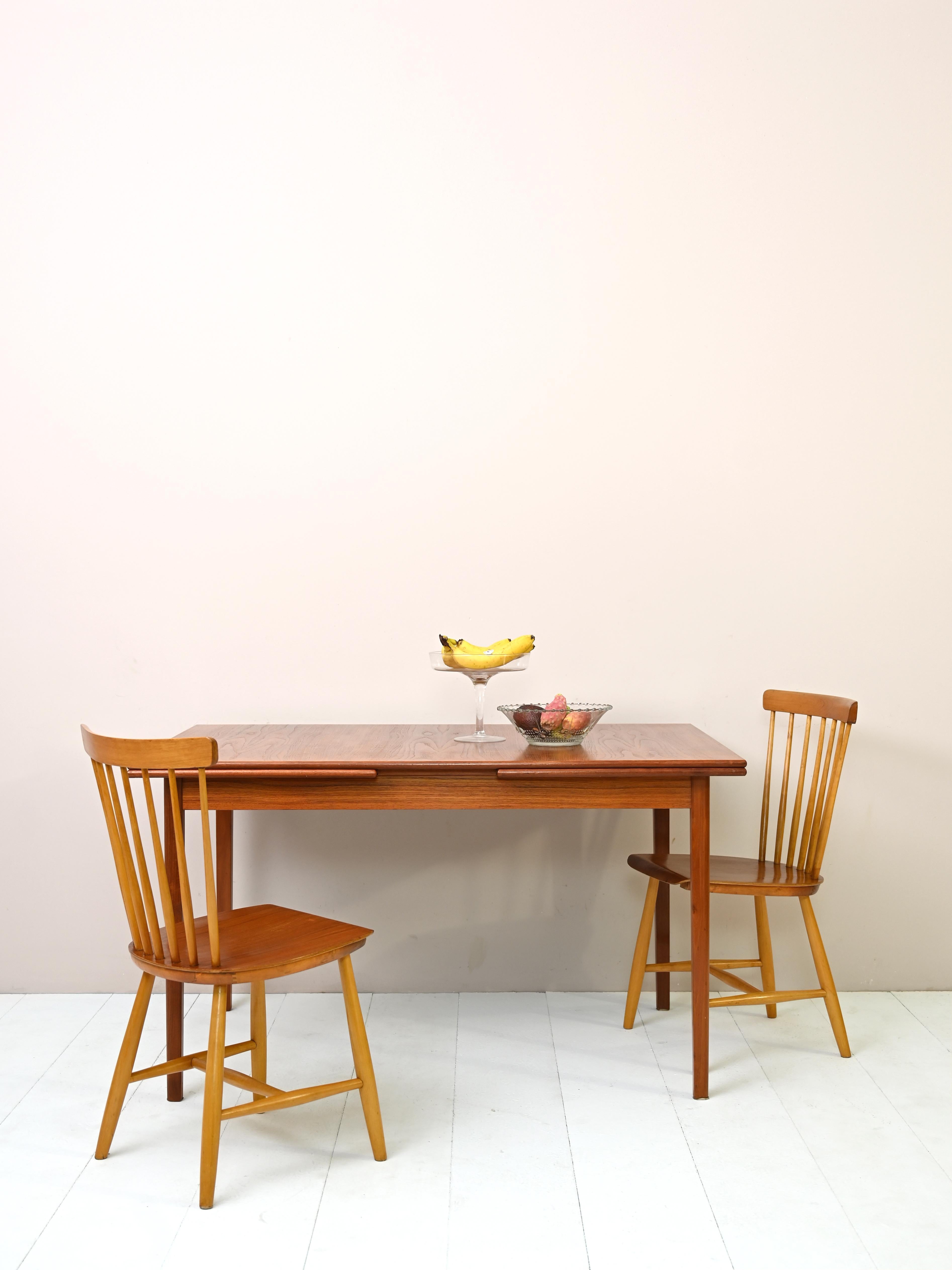 'Made in Denmark' extendable dining table.

Table dimensions open
W 234cm, D 90cm, H 74cm

Table dimensions closed
L 130cm, D 90cm, H 74cm

Vintage 1950s table with two extension leaves 52cm long. The long legs and curved-edged top are the