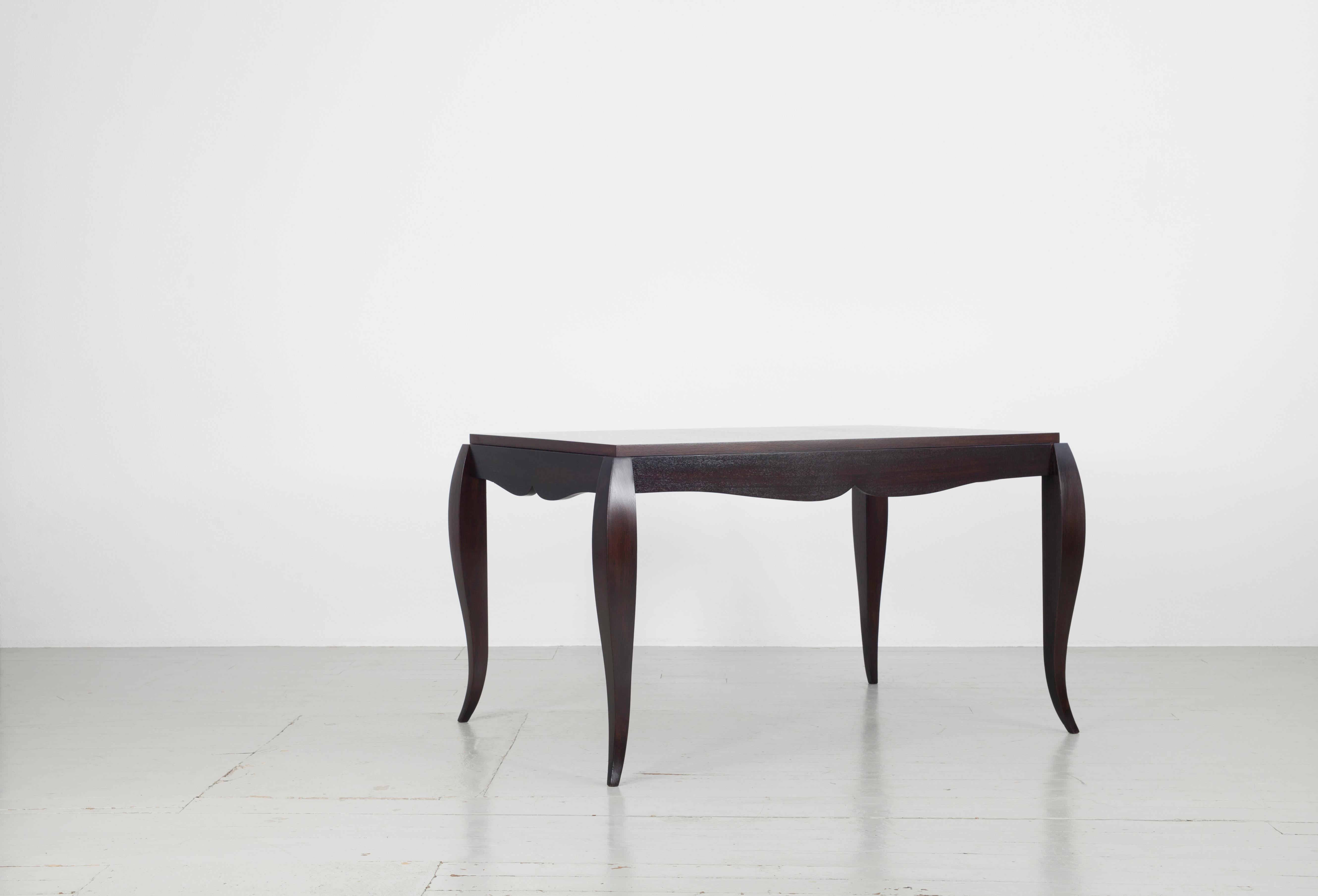 Table made of rosewood with playfully curved table legs and beautiful details in the finish of the table top and base. Strict elements of the 1940s are combined with curved elements that are more reminiscent of Biedermeier. There are table extension