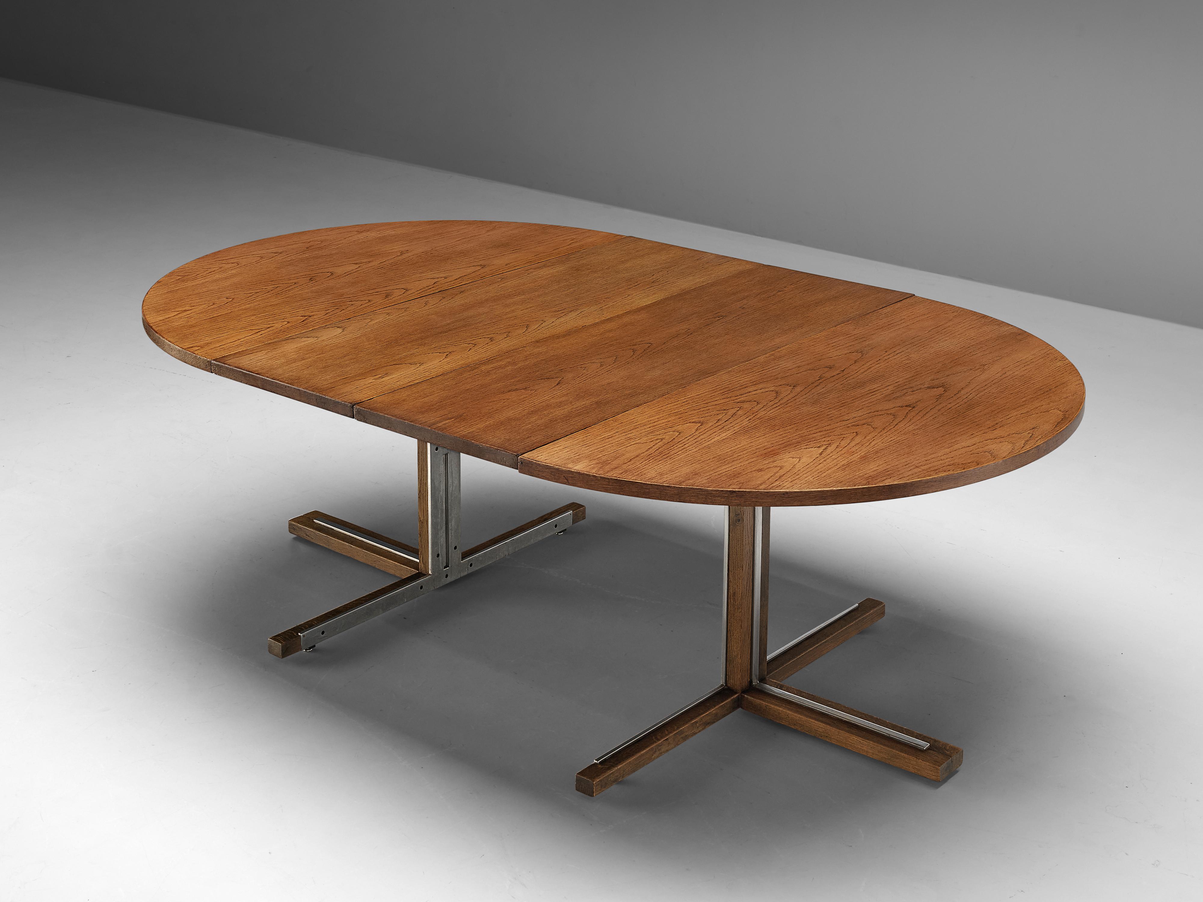 Dining table, oak, metal, Italy, 1970s

Beautiful dining table with extendable feature. When in its smallest form, the table has a round form and the legs create a cross. However, if it is extended, it turns into a great oval shape and the crossed