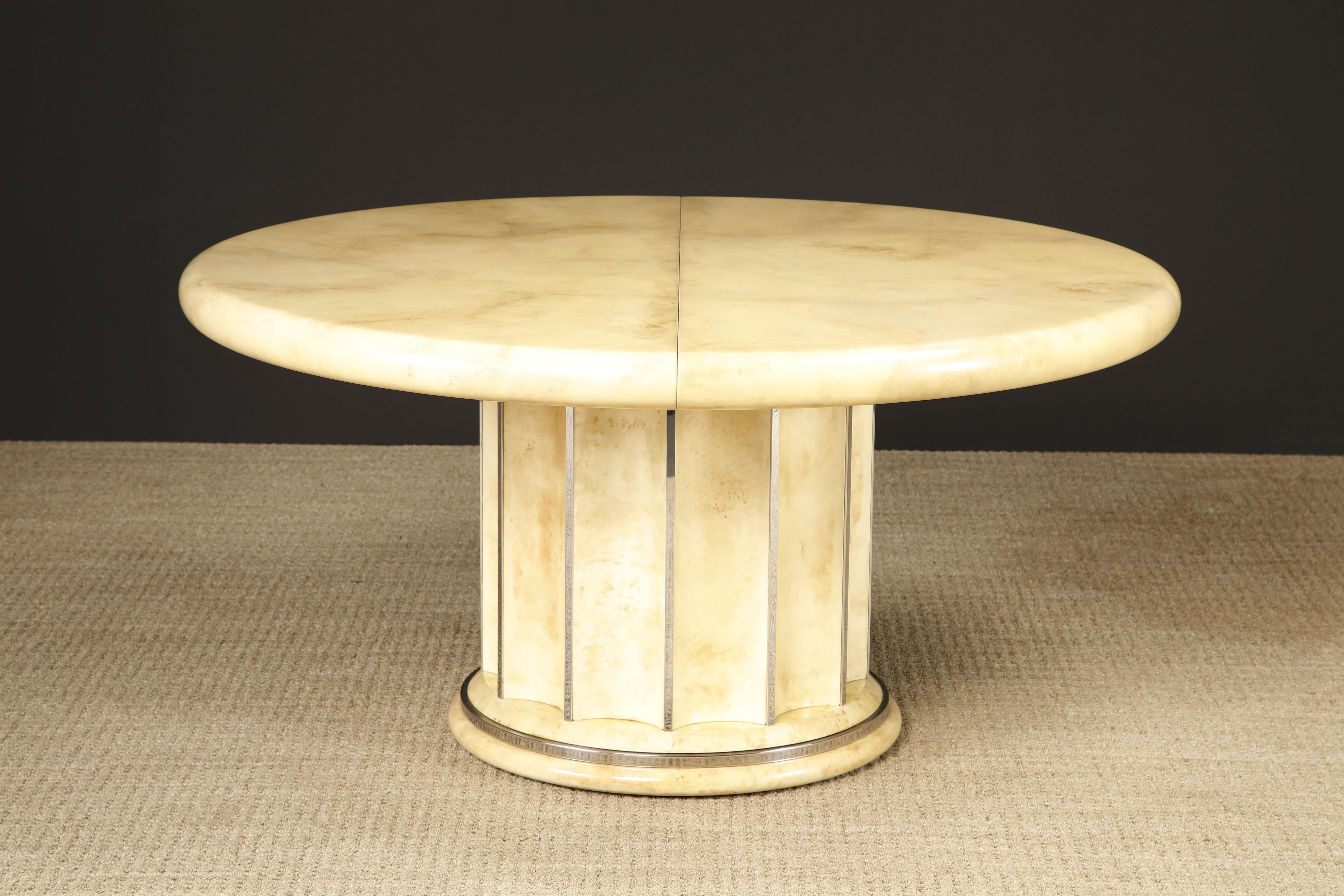 Simply exquisite is this lacquered goatskin dining table featuring a scalloped base with chrome details and a monumental size: 60