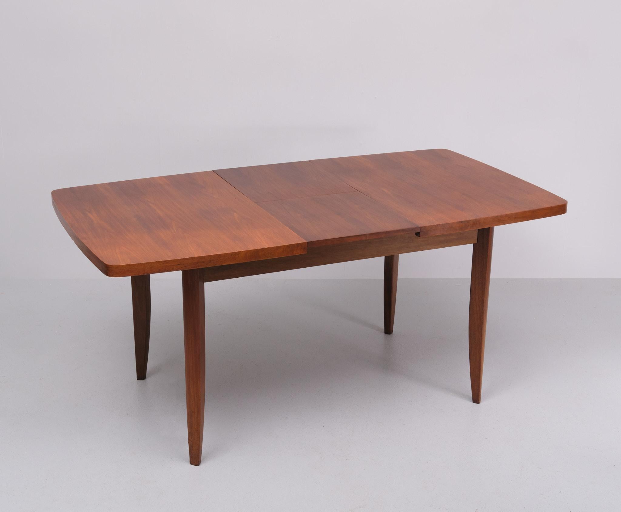 Very nice dining table , Beautiful design . Solid Nutwood legs . 
comes with a Extendable top . with a folding out extension .  128/168 cm                    1960s Very good condition . attrib to Jindrich Halabala
