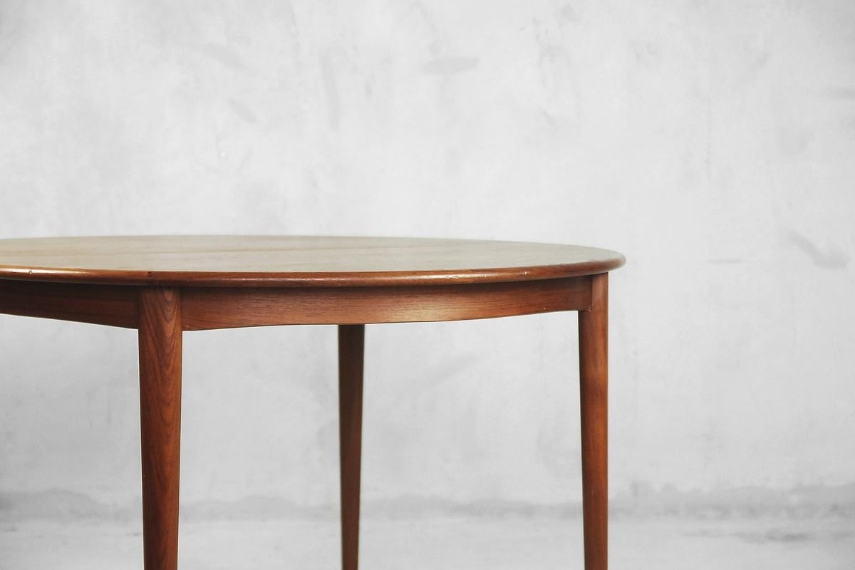 Questo tavolo da pranzo rotondo vintage è stato prodotto in Svezia negli anni Sessanta. È realizzato in teak massiccio e impiallacciato. Bello e pratico allo stesso tempo, passa da un diametro di 110 cm a una lunghezza di 200 cm grazie alla sua