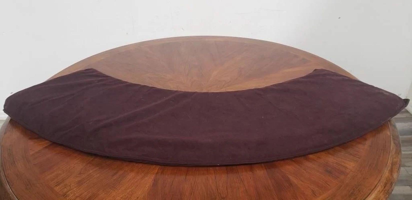 Extendable Round Walnut dinning table and game table With 4 leaves. Each leave is sleeved for protection ( four leaves in total. and connects to one another to be placed over the center table. The outside diameter of the table. 57 diam x 31h With