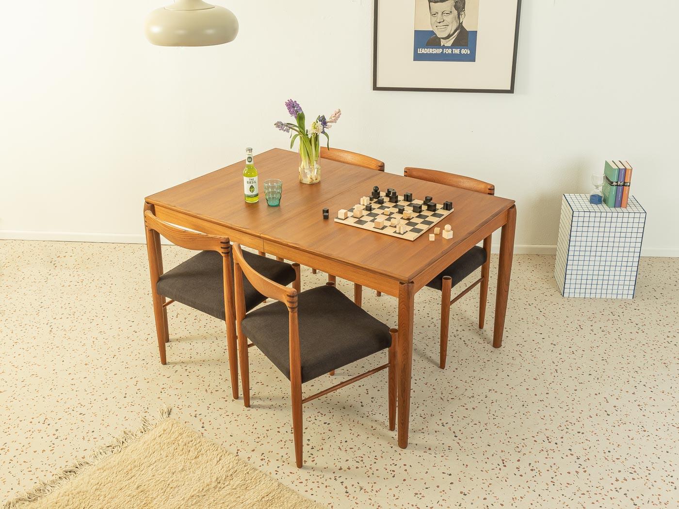 Rare extendable teak dining table from the 1960s by H.W. Klein for Bramin. Solid frame and veneered table top with solid wood edge. The insert plate can be stowed under the table top.

Quality Features:
- accomplished design: perfect proportions