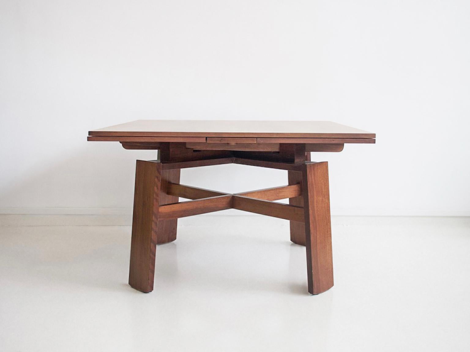 Square walnut table, model 612, designed by Silvio Coppola in 1964. Manufactured by Bernini in Italy. Extendable into a large dining table.

Literature: G. Gramigna, Repertorio del Design Italiano 1950-2000 per l'Arredamento Domestico, Torino