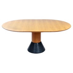 Extendible oval round dining table with oak top and stone base by Arnold Merckx