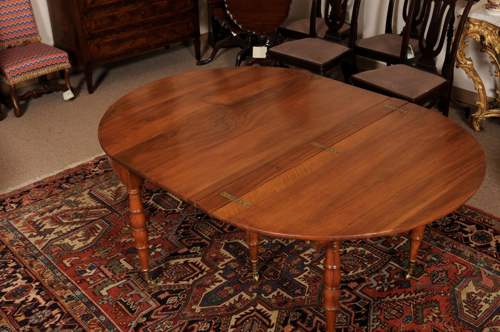 Extending 19th Century French Fruitwood Dining Table w/ 3 Leaves & Brass Castors For Sale 7