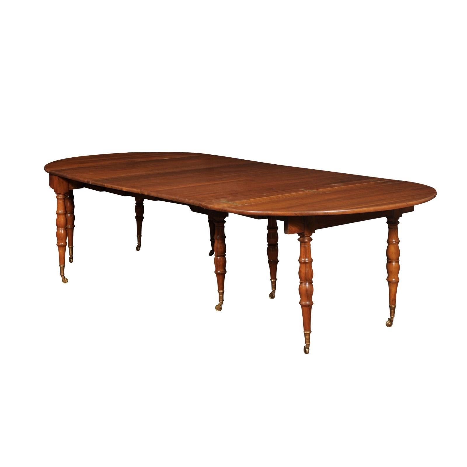 Extending 19th Century French Fruitwood Dining Table w/ 3 Leaves & Brass Castors For Sale 13