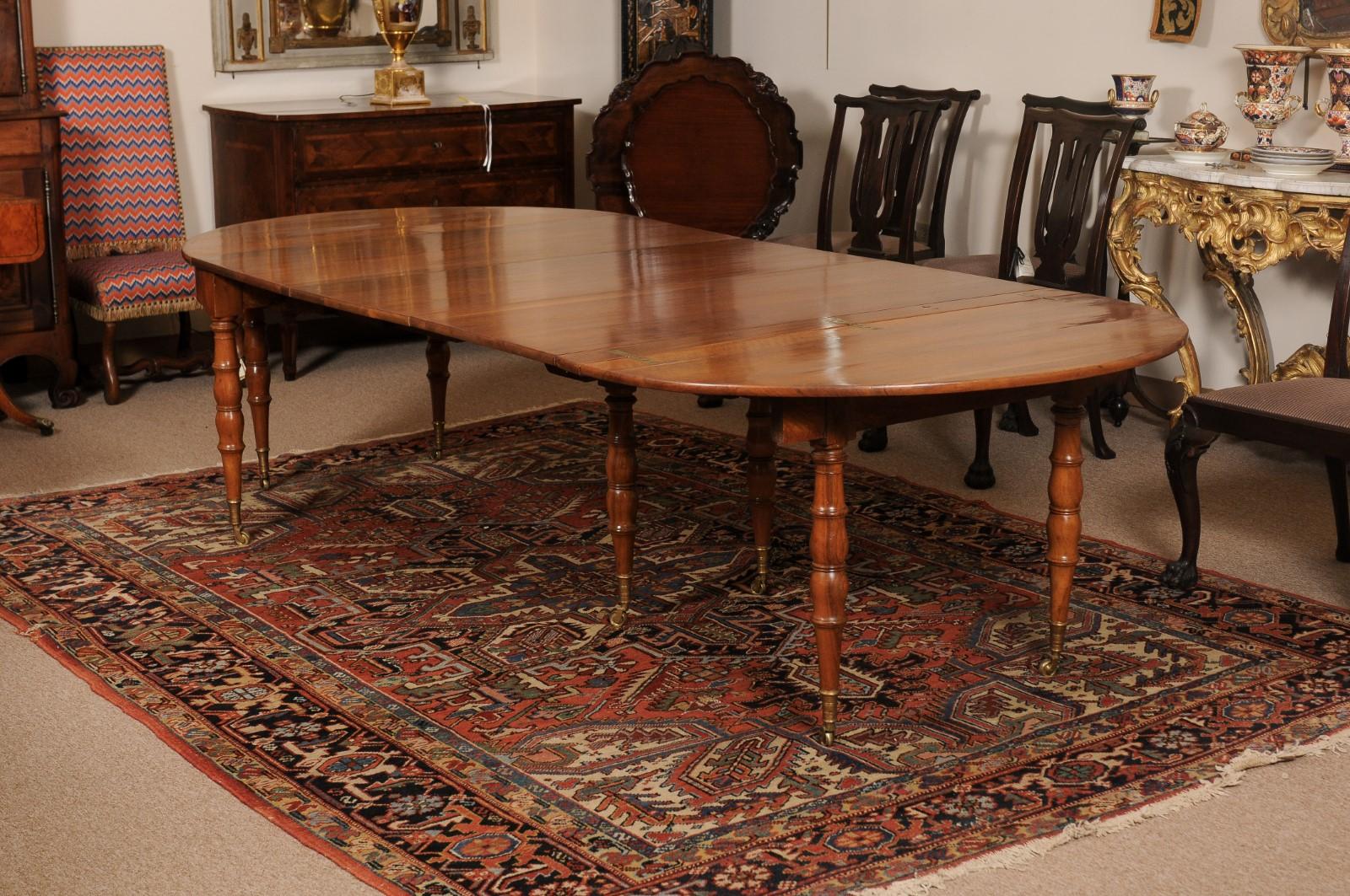 Extending 19th Century French Fruitwood Dining Table with 3 Leaves and Brass Castors