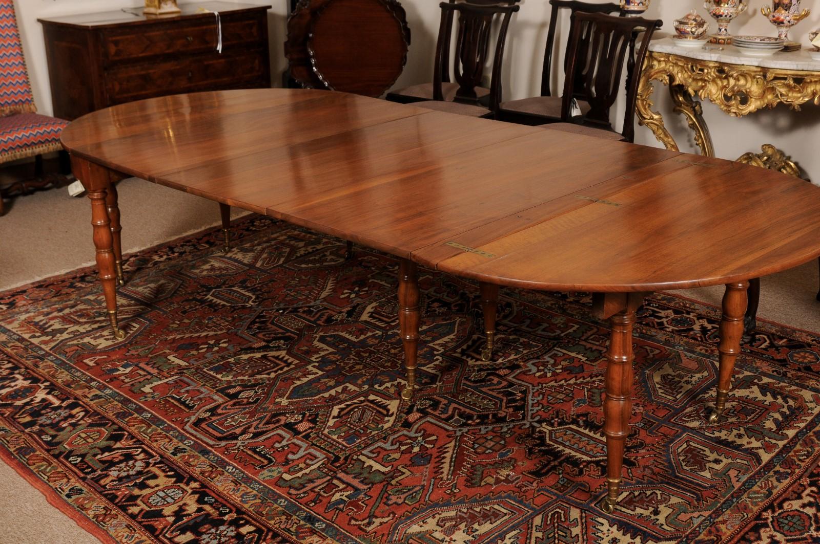 Extending 19th Century French Fruitwood Dining Table w/ 3 Leaves & Brass Castors For Sale 1