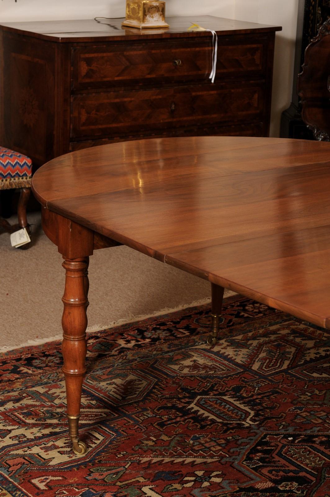 Extending 19th Century French Fruitwood Dining Table w/ 3 Leaves & Brass Castors For Sale 2