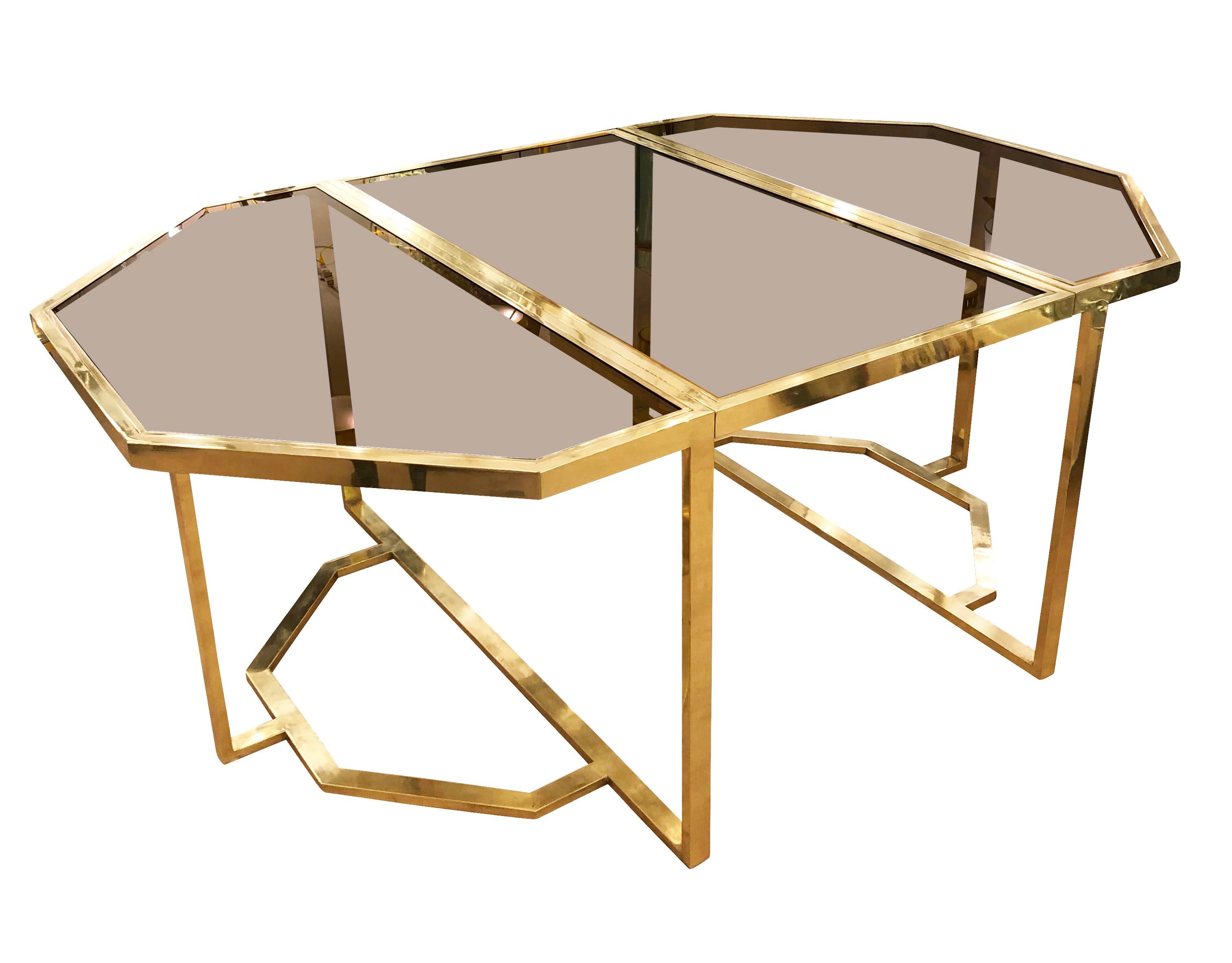 Octagonal dining table by Romeo Rega with brass framing and smoked glass tops. At the center it has a folding leaf to extend the piece by 28”. The two ends can also be used as consoles.

Condition: Excellent vintage condition, minor wear