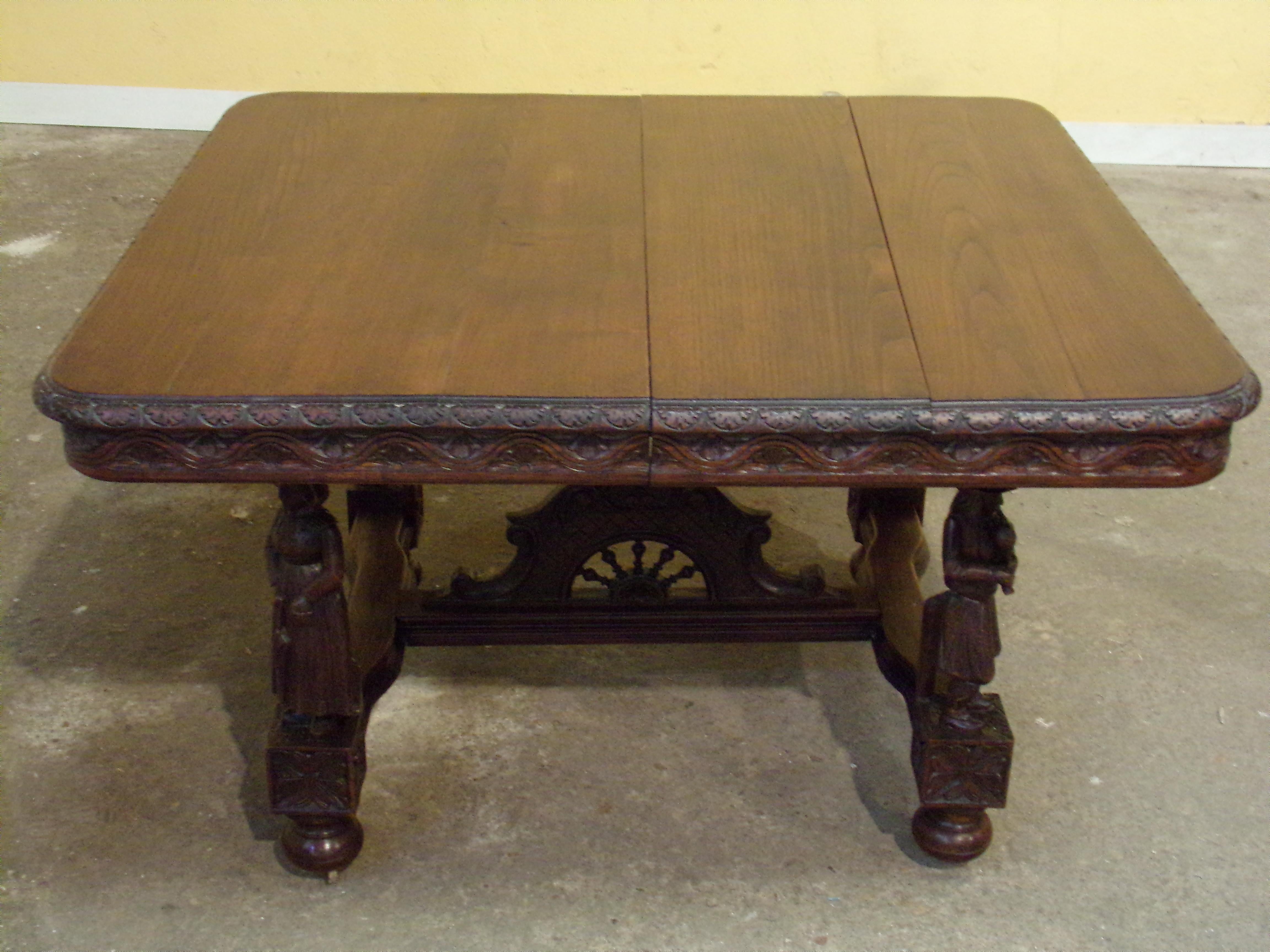An impressive hand carved oak Breton dining table with two leaves is able to seat 6 to 12 .This fine table is in the l Breton style depicting people in traditional dress. These unusual pieces were of the given to couples on their marriage day. Like