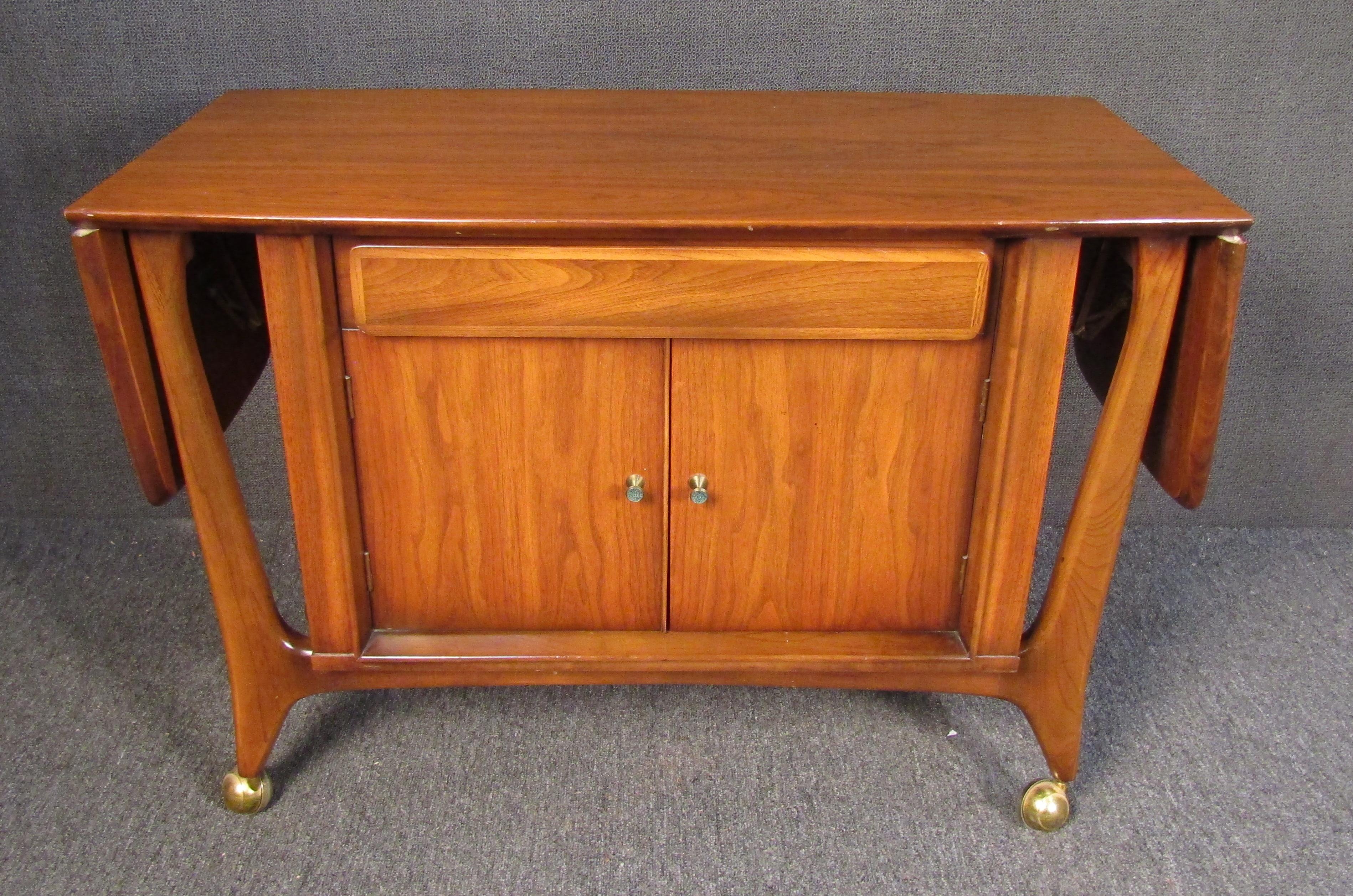 Mid-Century Modern console with dry bar interior. Extends 42-68