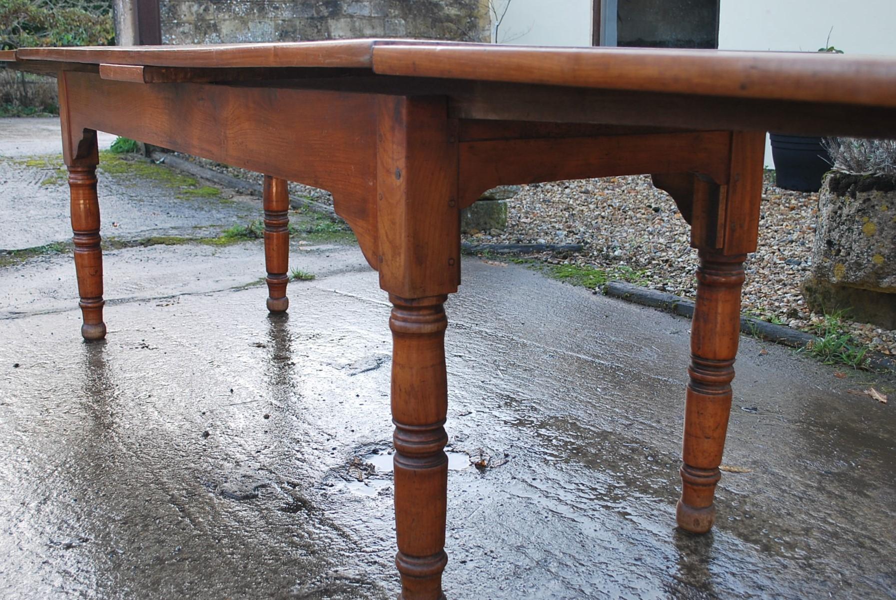 Hutton-Clarke Antiques is delighted to present an exceptional French Extending Farmhouse Table, crafted around 1840. This table is made from cherry wood and boasts a truly unique feature—an unusual figured top that immediately draws the eye.

What