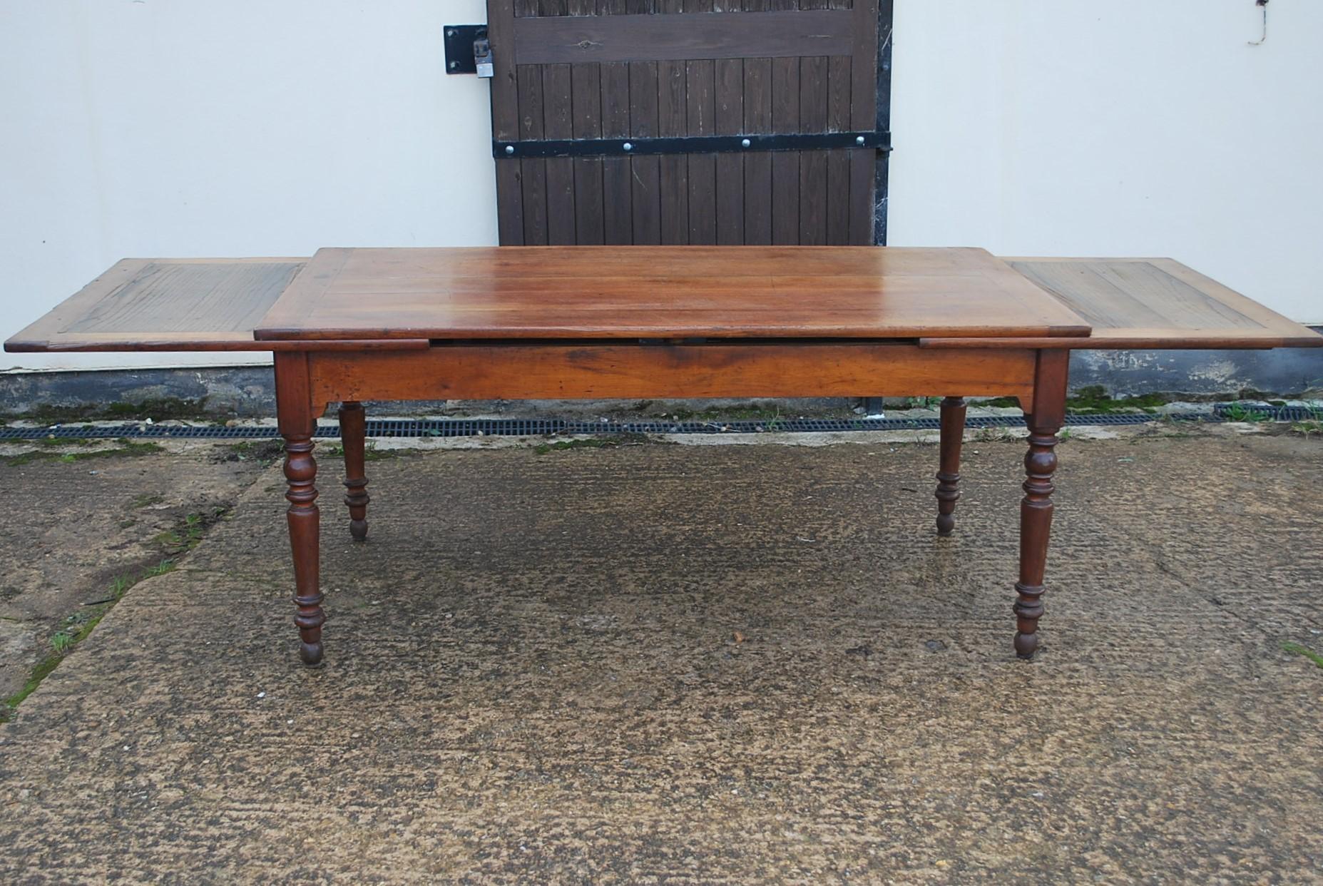 Hutton-Clarke Antiques is delighted to present an exquisite French extending farmhouse table, dating back to around 1860. This charming piece boasts a timeless design, with turned legs and the added convenience of drawers at either end. The table