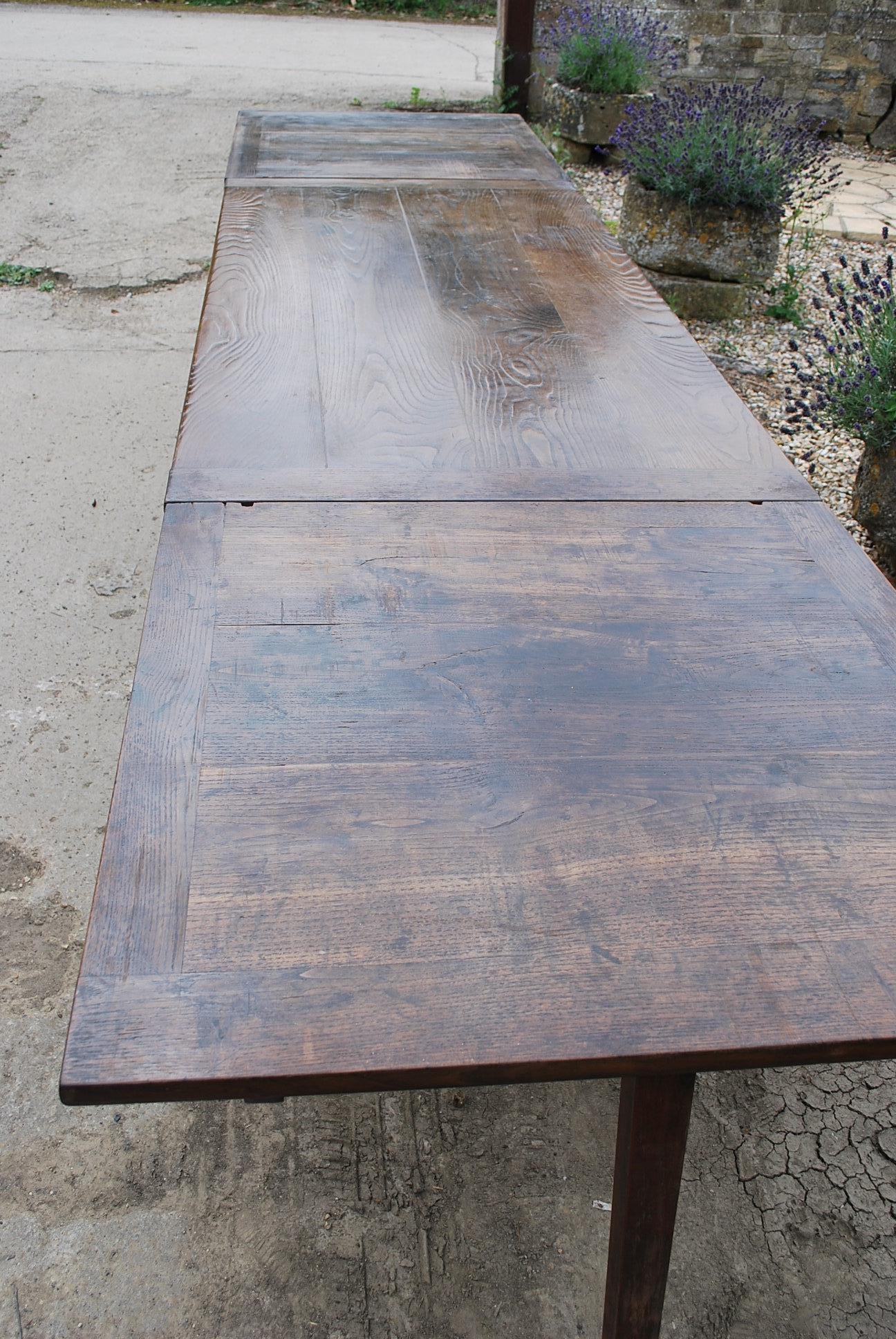 A good quality French extending farmhouse table with a lovely patinated chestnut top and original cherrywood base, circa 1870. The top remains in place and two long slides pullout / pull-out with a supporting leg that folds down. On the other side
