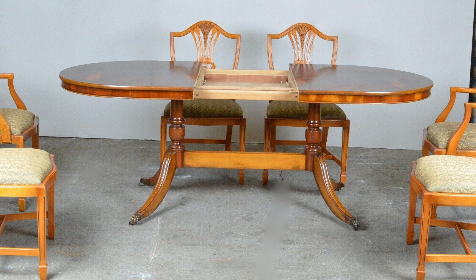 We are delighted to offer for sale this vintage burr Yew wood extending oval dining table with lion hairy paw castors and 6 chairs with spade feet. A good-looking and well-made table, this is a 20th century example, the legs are also yew wood with a