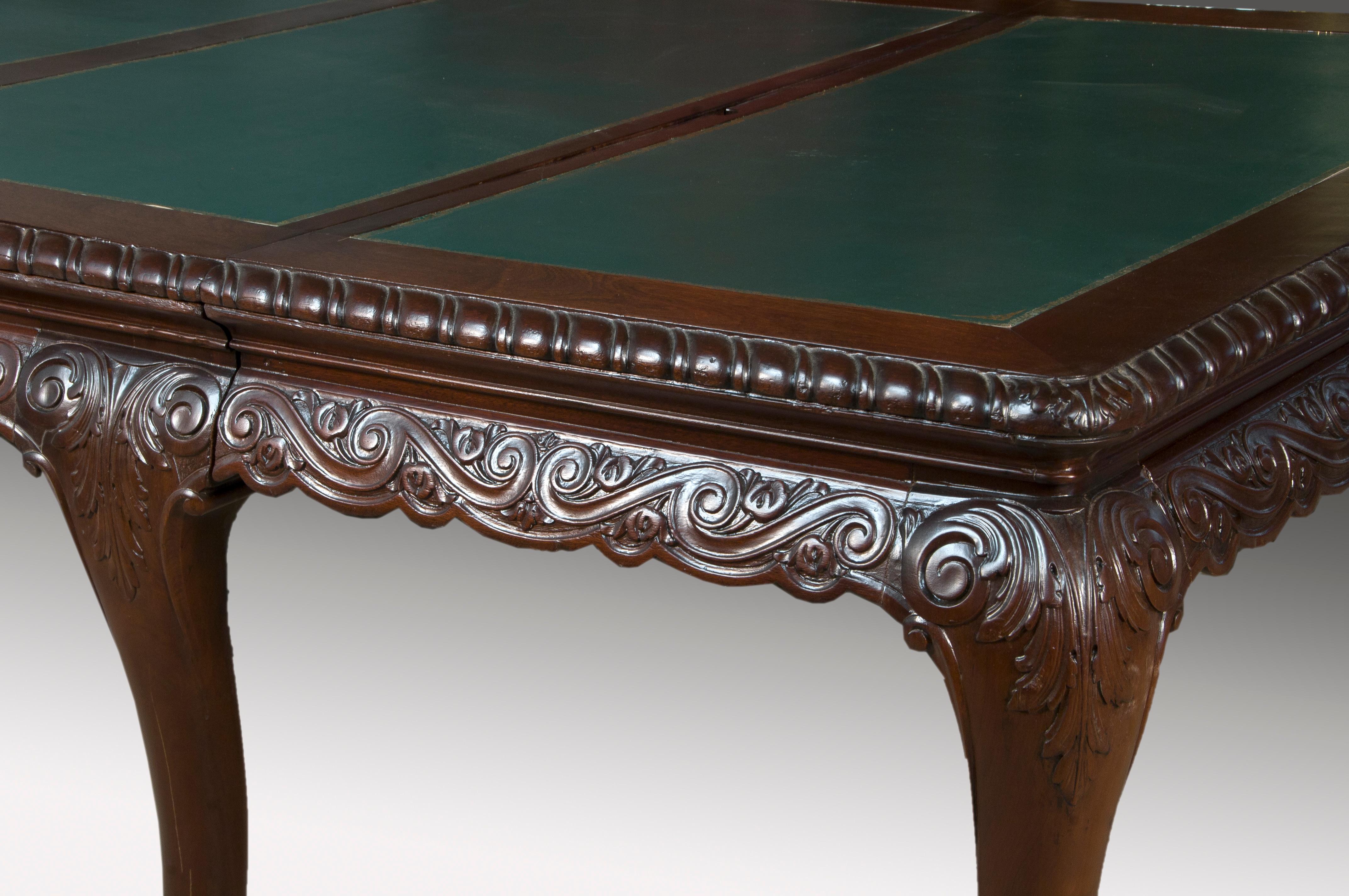 Rectangular mahogany table with eight legs ending in small metal wheels. It has a system of 