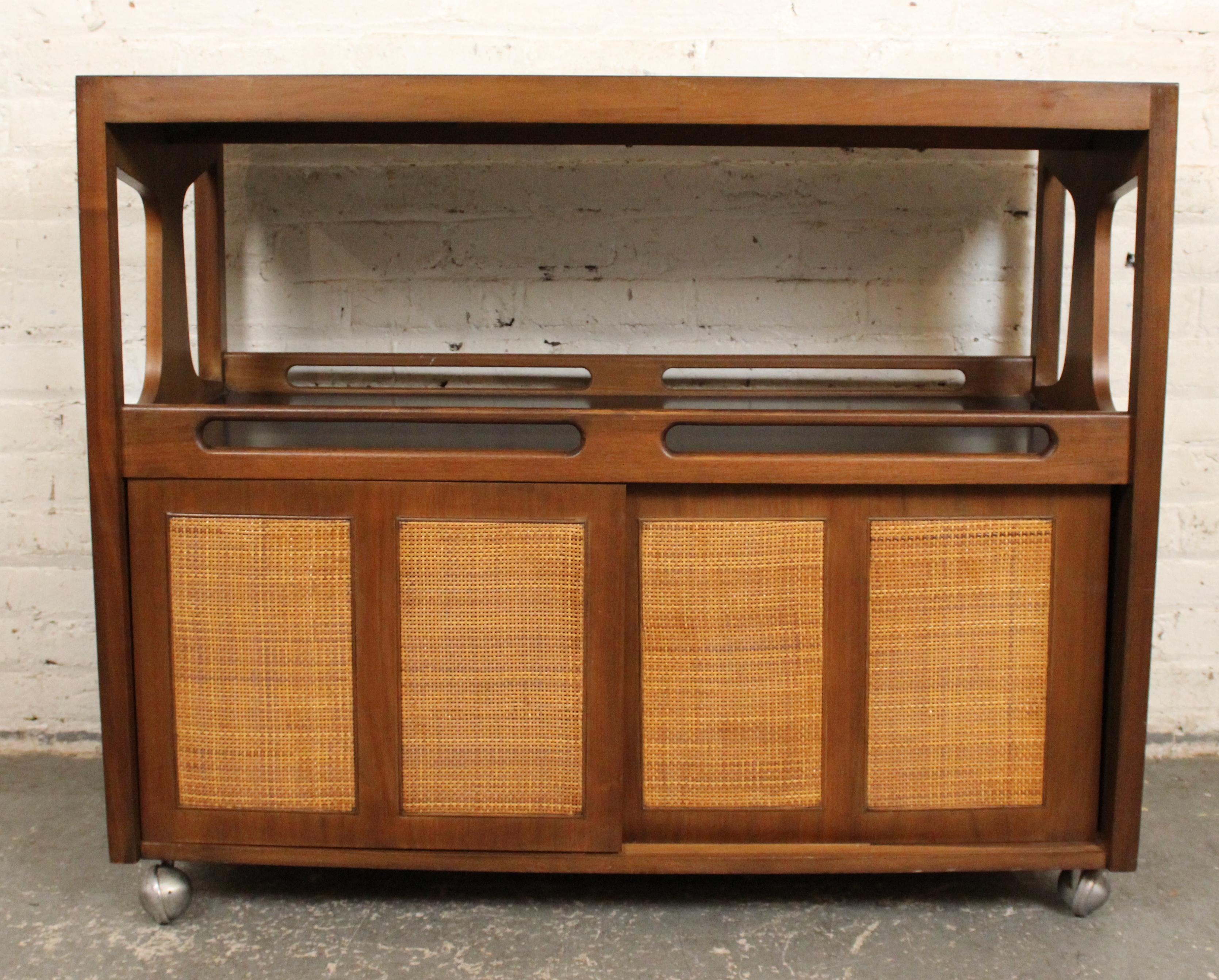 Mid-century modern rolling cart with bottom storage and expanding top. The draw leaves pull out to expand from 42