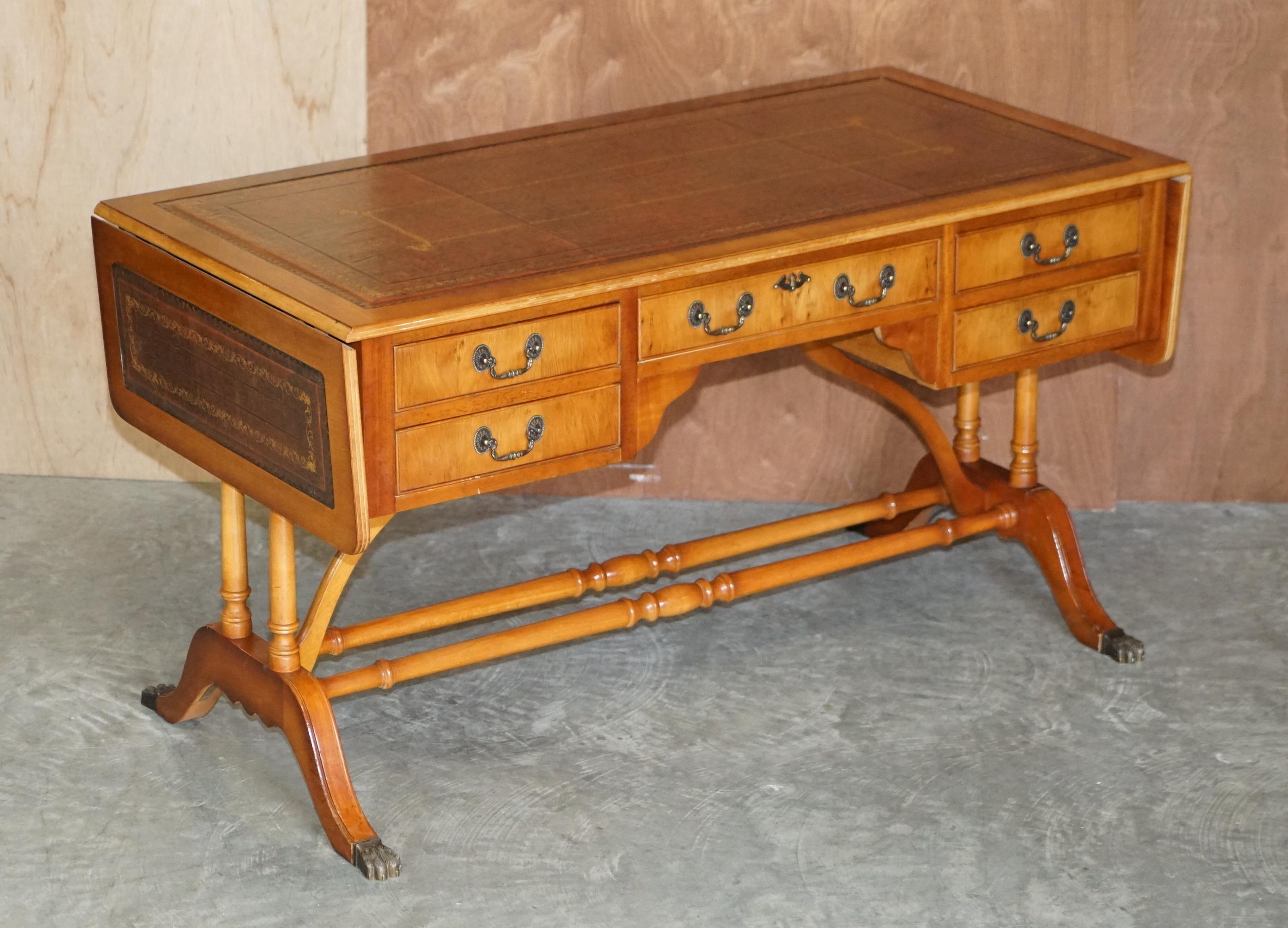 We are delighted to offer for sale this stunning Burr yew wood writing table or desk with extending, gold leaf embossed brown leather top 

A good looking and well made piece, its based on a design for a Regency sofa table however this has the