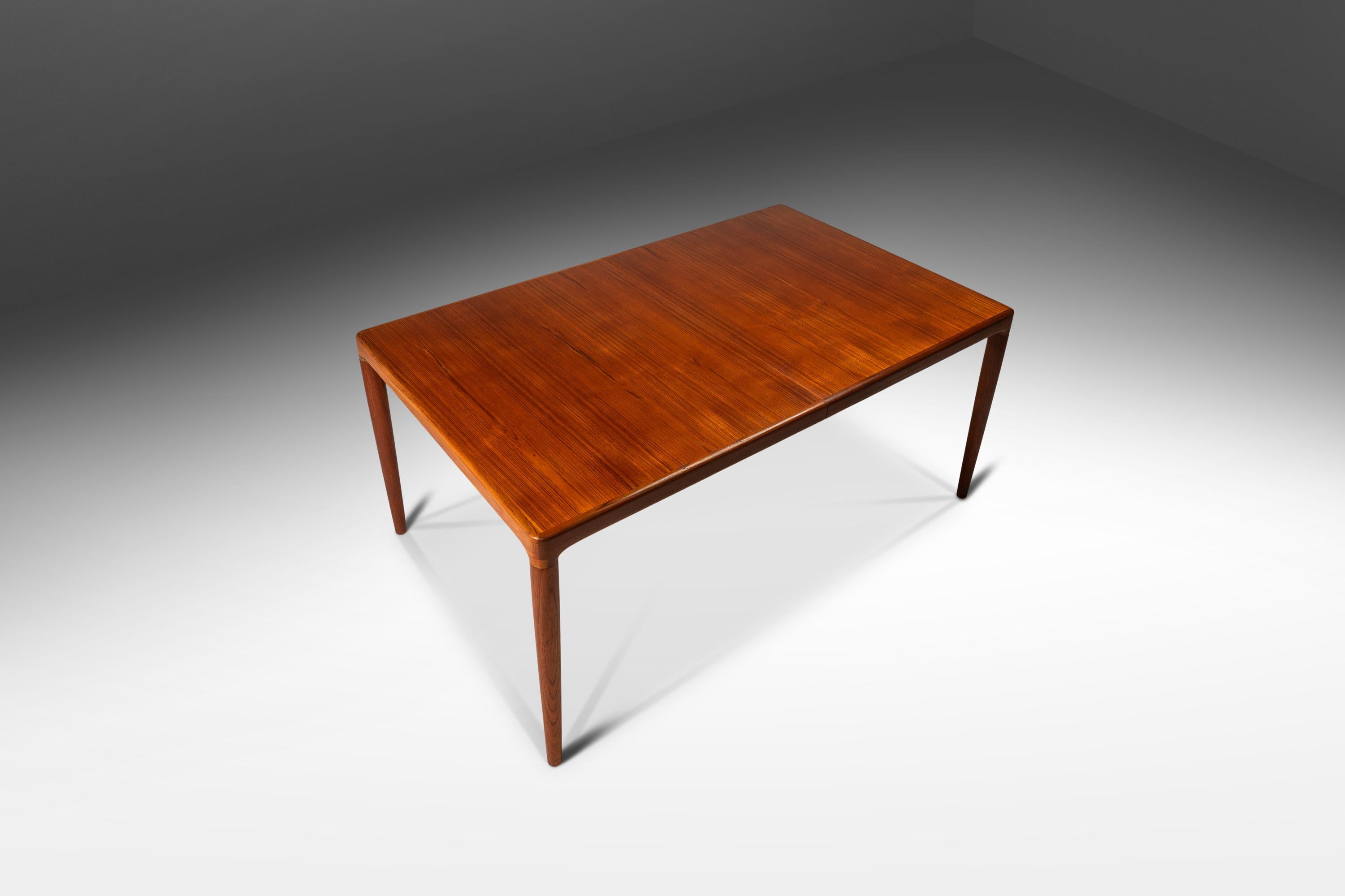 Introducing a rare, extension dining table designed by the influential H.W Klein for the lauded Bramin Møbler company. Crafted from a mix of solid and veneered Burmese teak with exquisite woodgrains and intricate woodworking this gorgeous table can