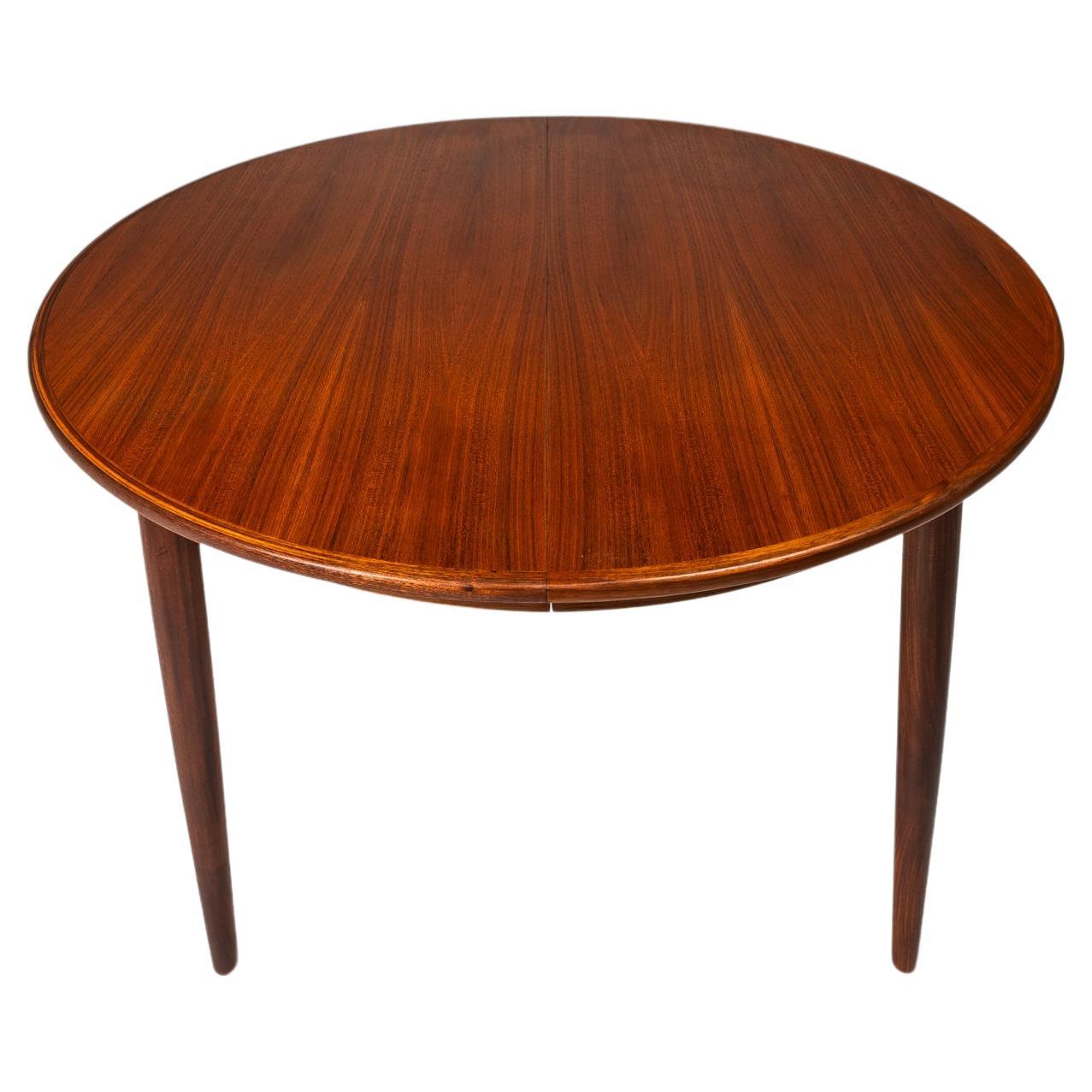 Introducing an elegant, Danish-made expansion dining table constructed by Gudme Møbelfabrik in the late 1960's. Equal parts beauty and functionality this extraordinary extension dining table is in 100% original, vintage condition. Constructed from a