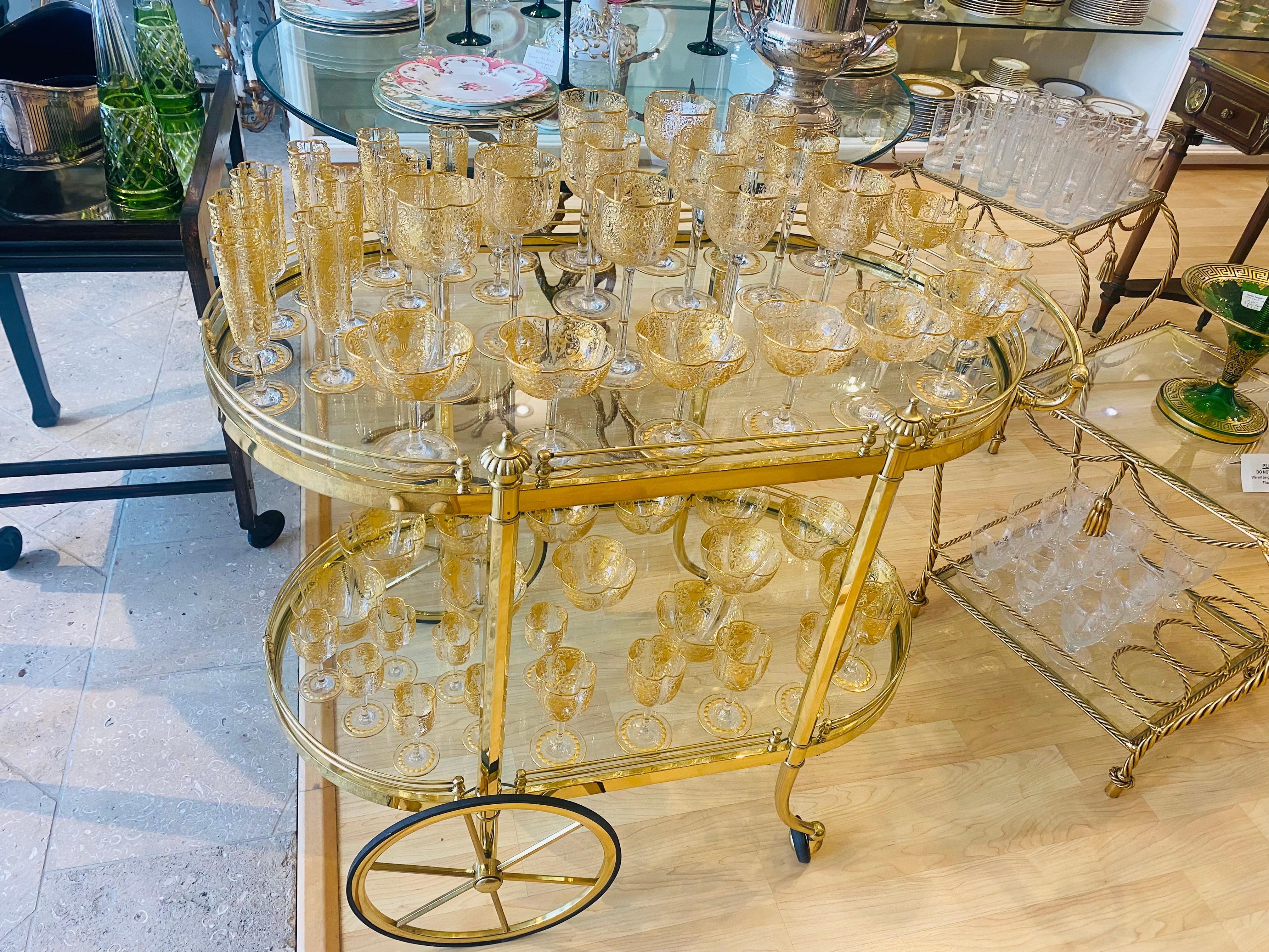 So nice to have over 50 pieces of beautifully blown quatre foil shaped crystal serve ware. By the re known firm of Moser, this 19th century set features delicate cut floral designs with their unique shape. Accented with lots of 24 karat gold