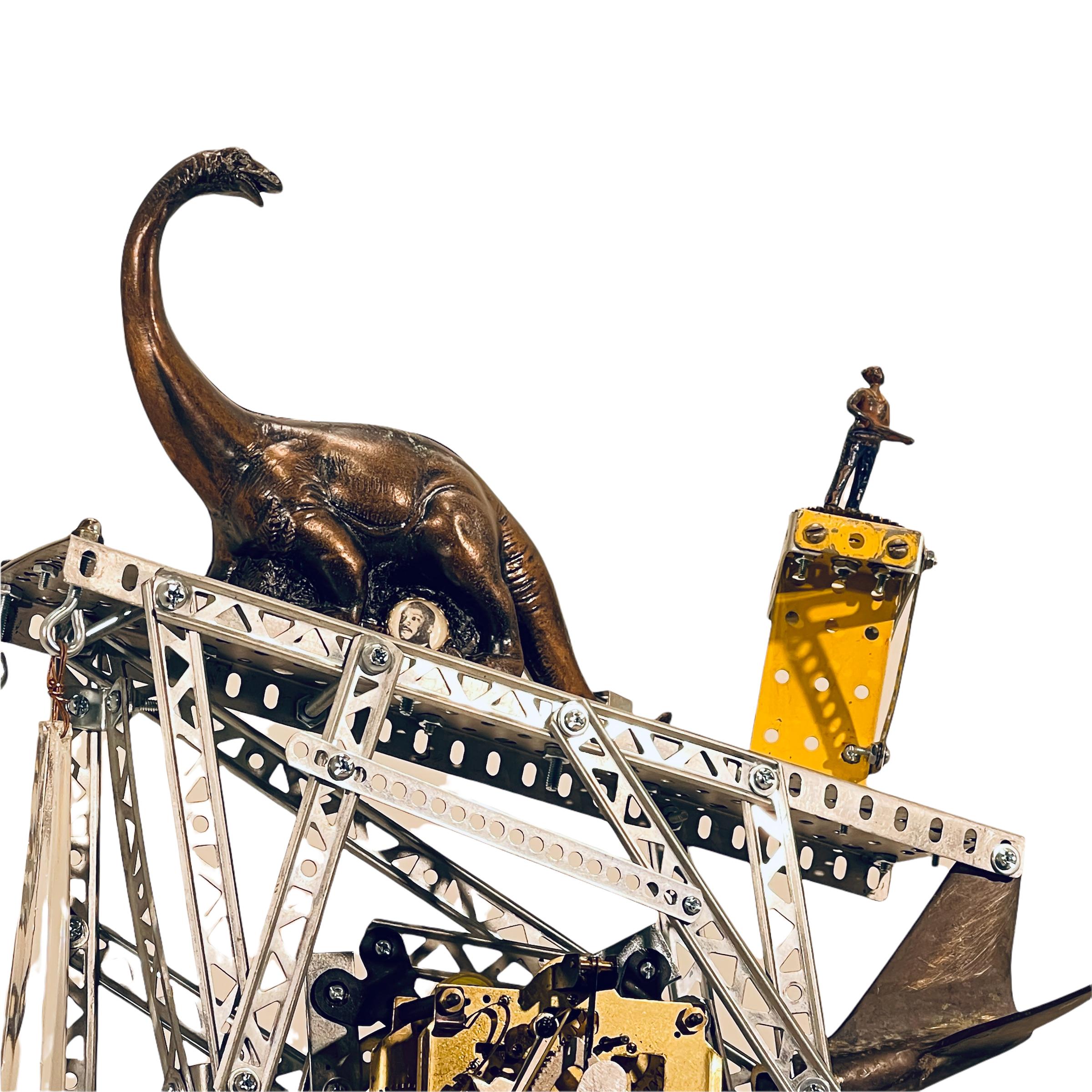 Culled together with the idea of extinction, John Seubert presents this working clock which includes a dinosaur, Aunt Jemima, and a jet colliding with a building in this ensemble piece. Created with found objects and ephemera, this working clock