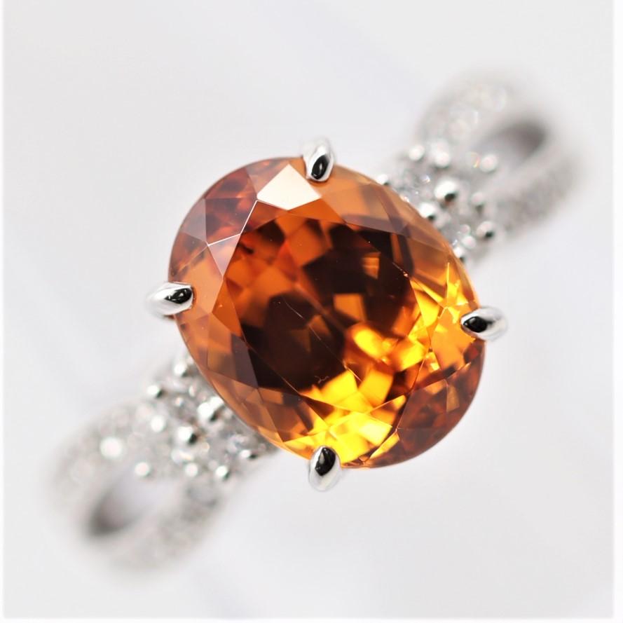 A superb spessartine garnet weighing 5.86 carats takes center stage of this lovely platinum ring. The garnet has an extra-fine royal vivid orange color giving it the trade name “mandarin.” It is accented by 0.37 carats of diamonds, cluster set on