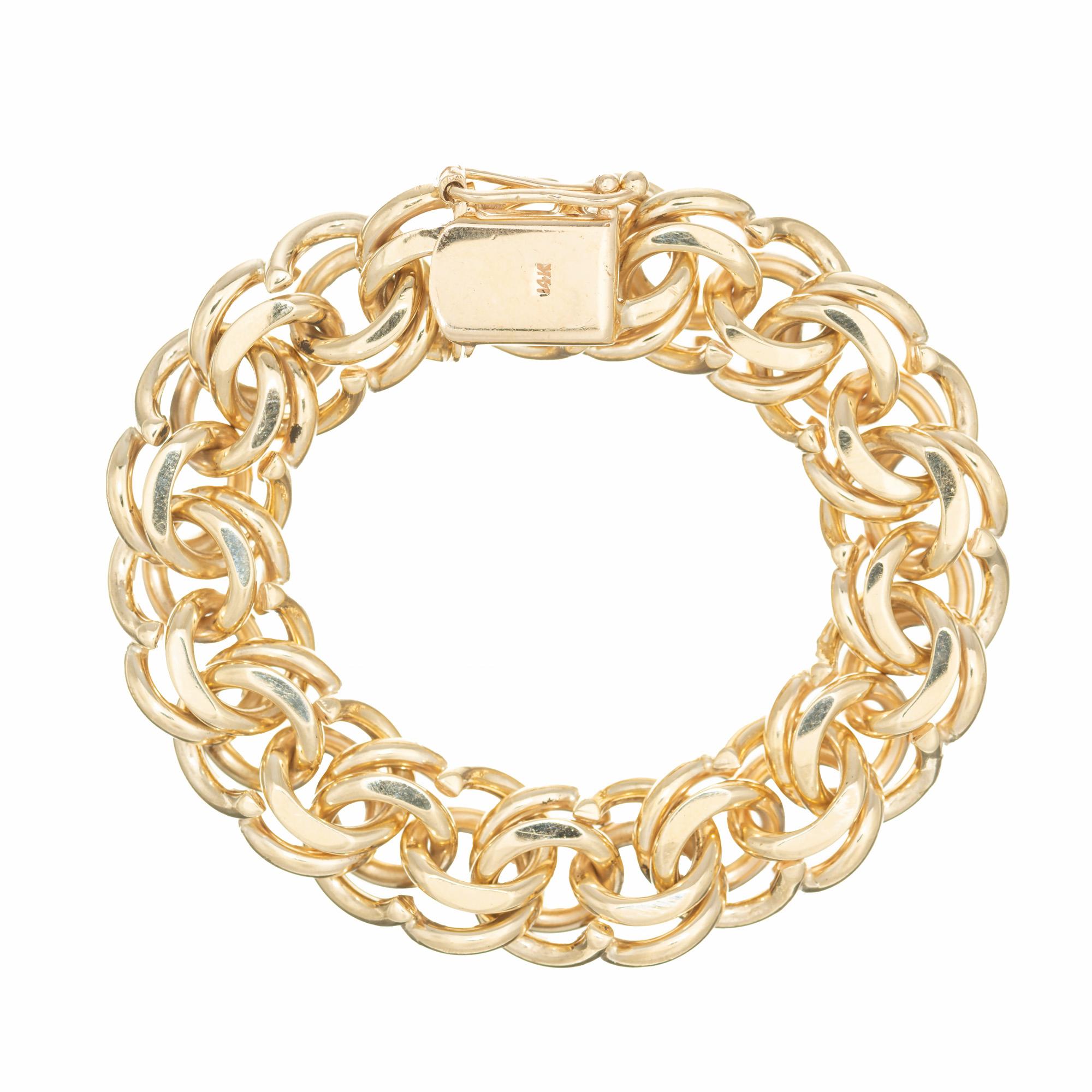 Vintage 1950's extra heavy solid double link charm bracelet with secure catch and safety. 8 inches long. 

14k yellow gold 
Stamped: 14k
88.7 grams
Total length: 8 Inches
Width: 16mm
Thickness/depth: 7.8mm

