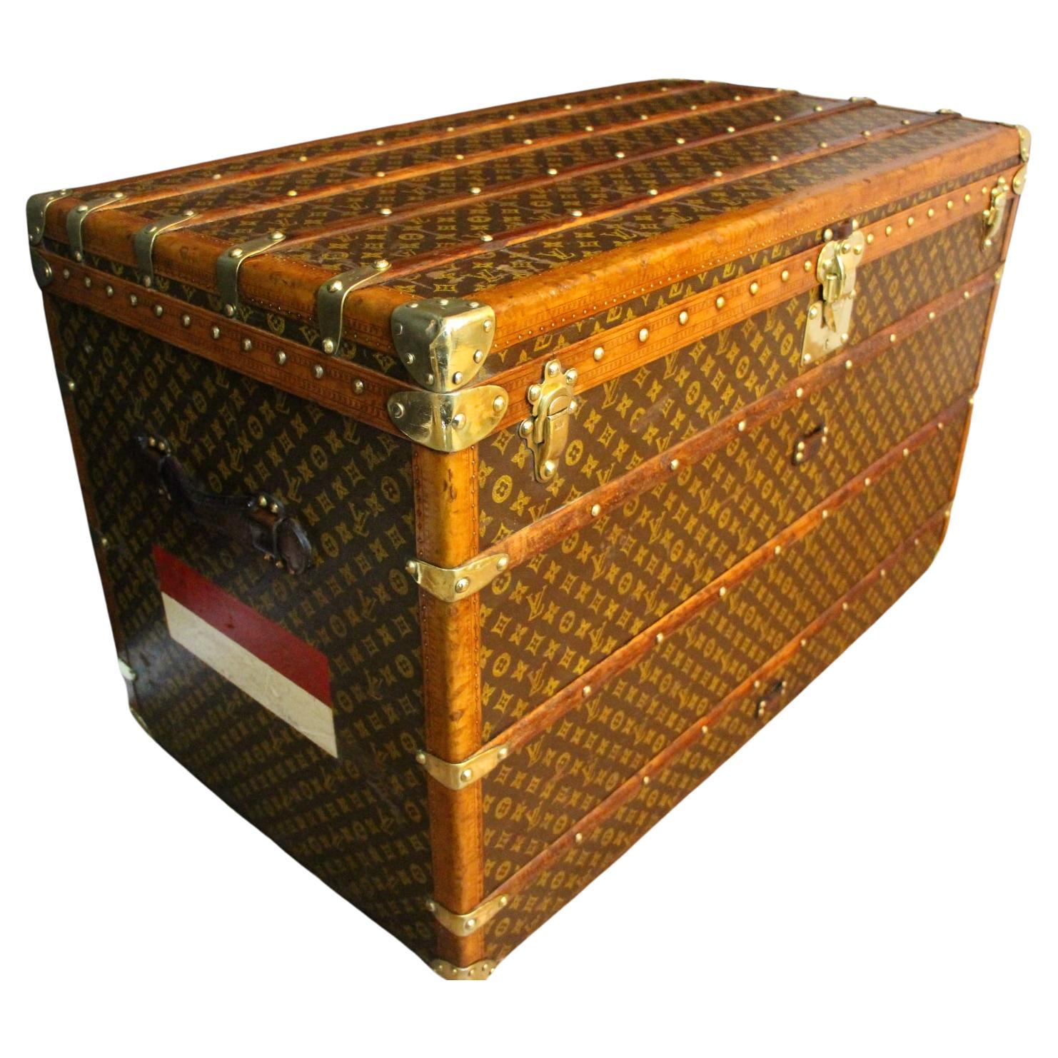 This superb Louis Vuitton steamer trunk features stenciled monogram canvas, honey color lozine trim, LV stamped solid brass locks and studs as well as solid brass side handles and brass corners. Its customized painted red and white stribes add a