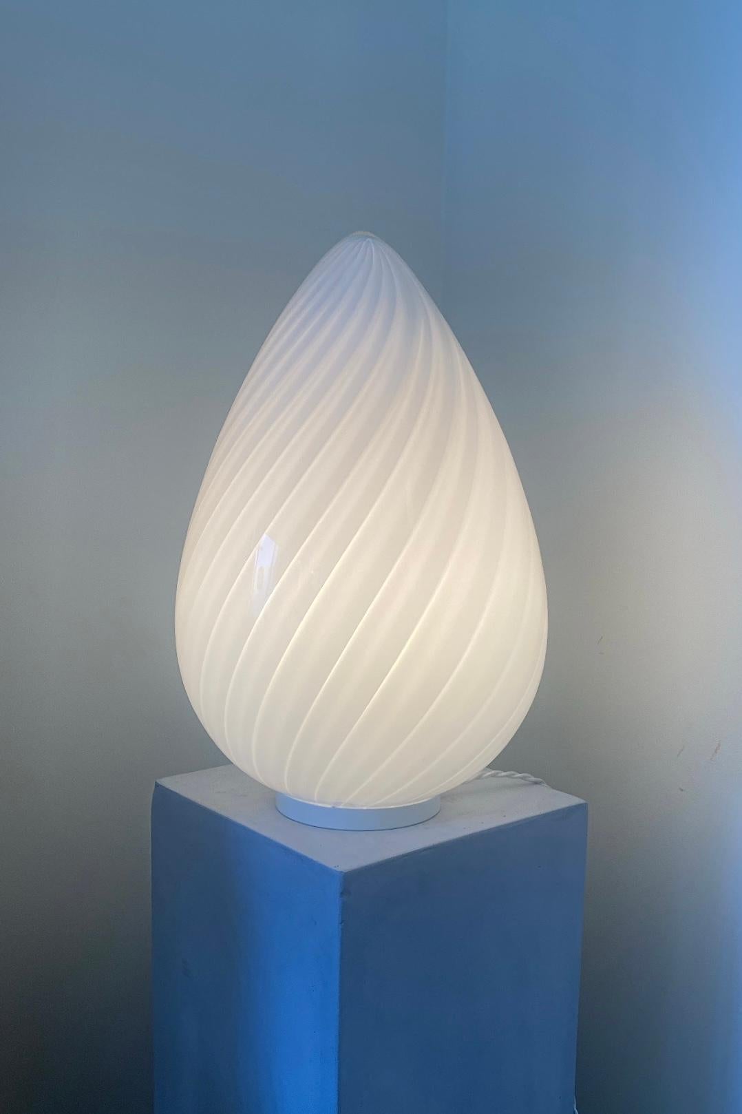 Vintage Murano egg lamp that can be used as a table lamp or floor lamp. Mouth blown in white opal glass with swirl in a beautiful oval shape like an egg and is therefore known as ''egg lamp''. An absolutely fantastic, sculptural lamp. Handmade in