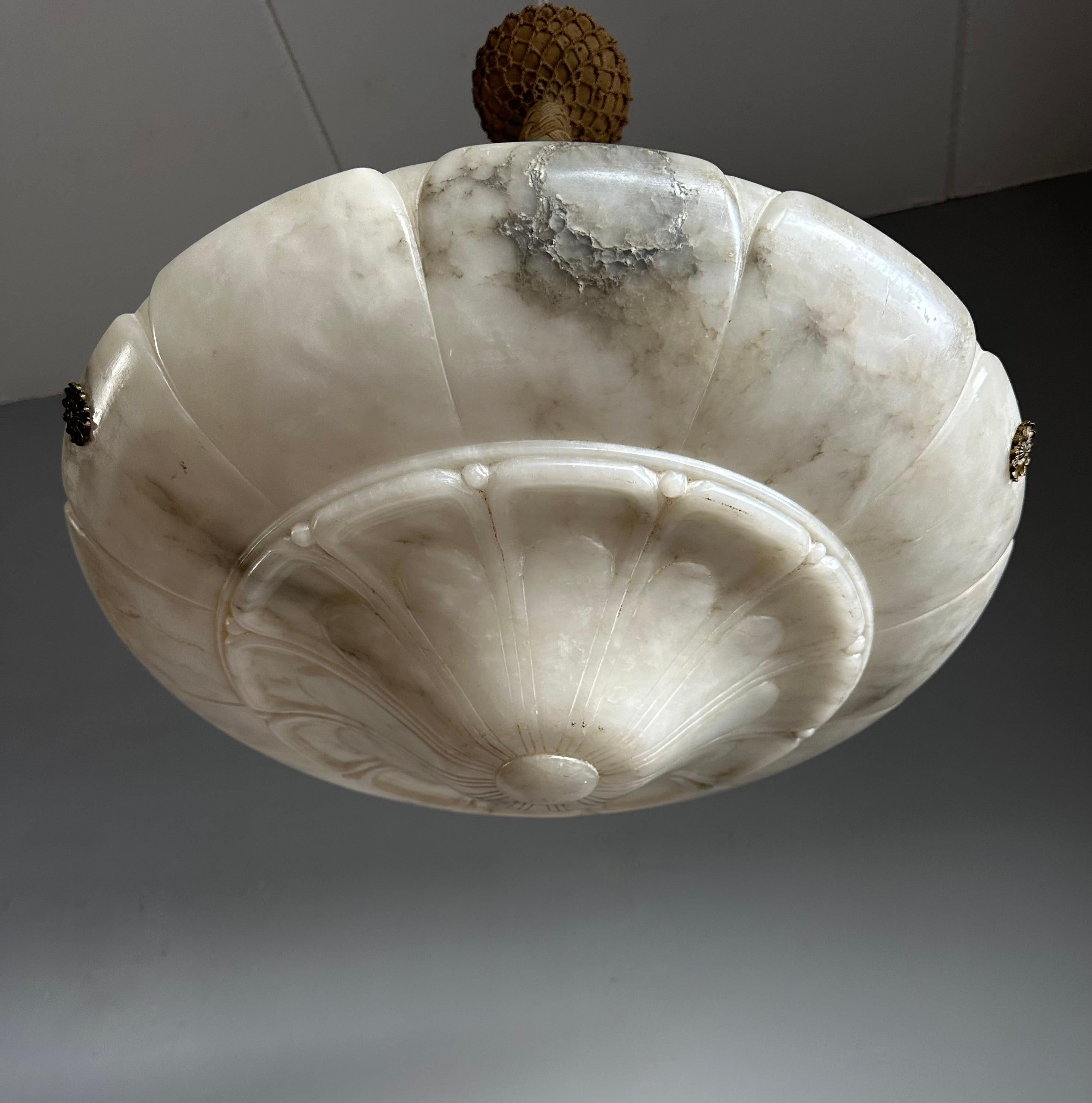 Top class antique chandelier with a unique alabaster stylish flower design shade and perfect hanging on a hand-knotted rope and canopy.

Thanks to its extra large size and mint condition this alabaster chandelier will light up your days and evenings