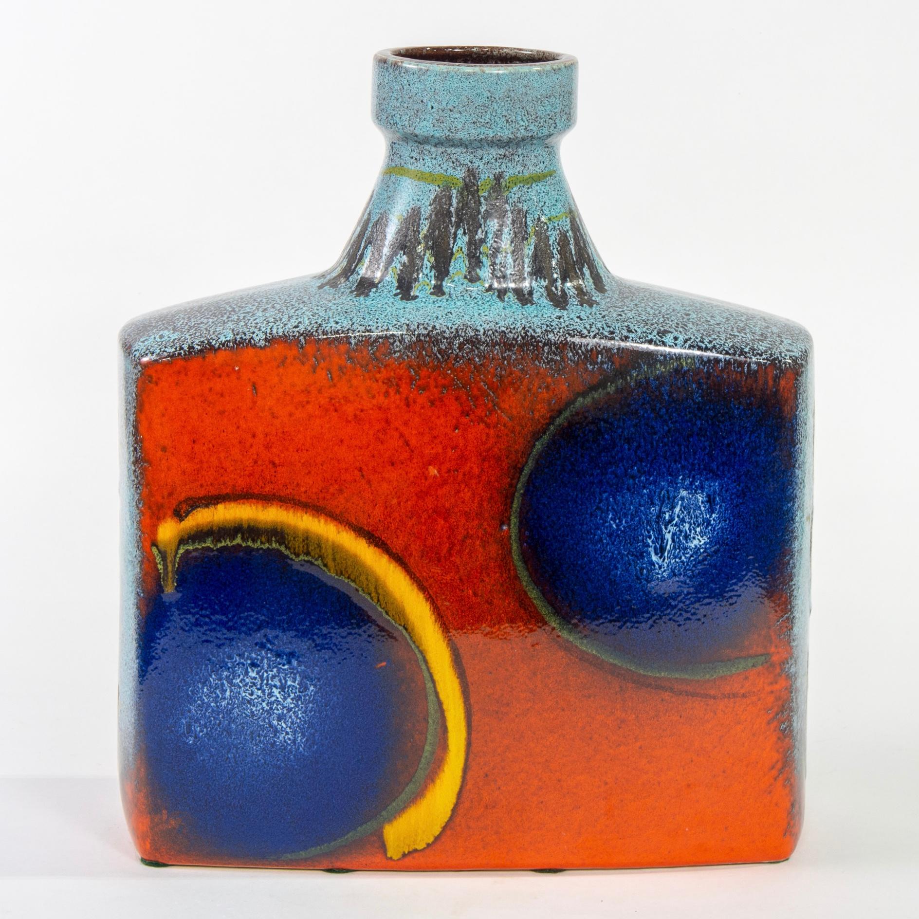 Extra large ceramic vase by Scheurich of W. Germany is marked 281-39, circa 1960s. Standing just under 16” tall, this vase has a flat, rectangular body, squat neck and colorful abstract glaze in fire orange, cobalt blue and aqua. Very good vintage