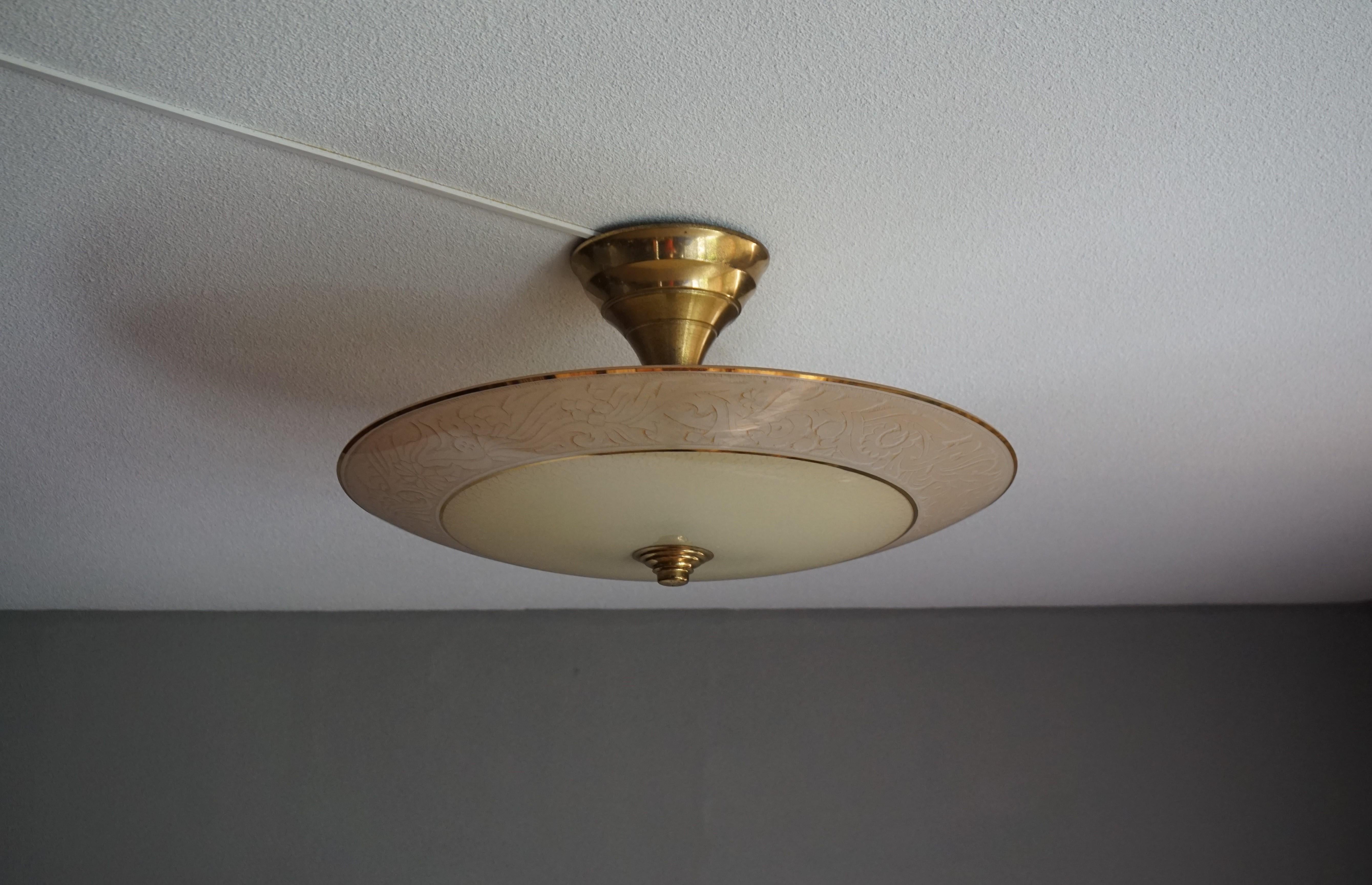 Impressive and beautiful Mid-Century Modern ceiling lamp.

This rare size light fixture has a beautiful look and feel and you will hardly ever find a light fixture from the Mid-Century Modern era with a larger and more stylish glass shade. If you