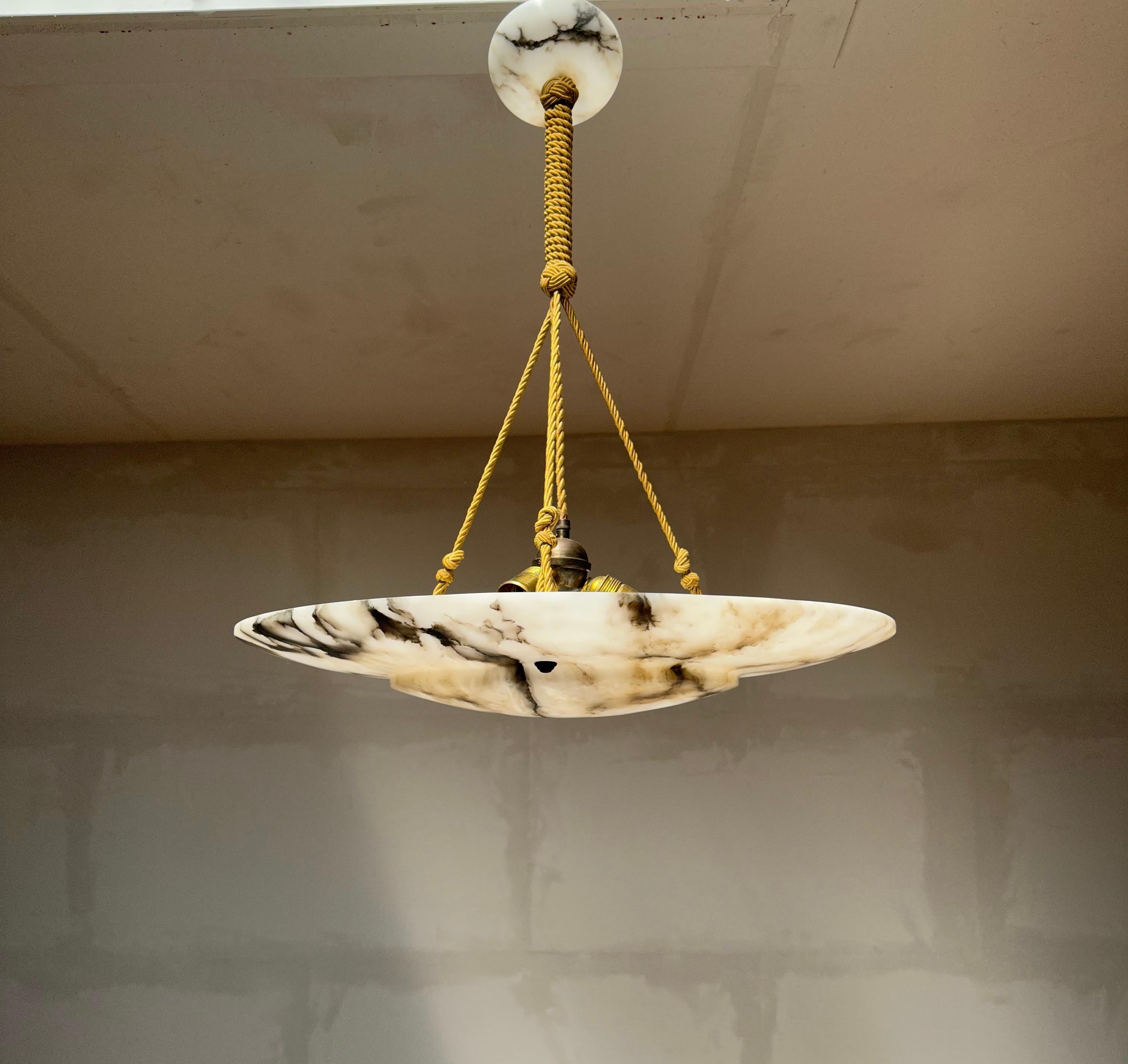 One of the largest antique alabaster flush mounts from the early 1900s.

This rare, almost flat and extra large size alabaster light fixture also is of a beautiful design. The beautiful and polished alabaster shade comes with a layered design