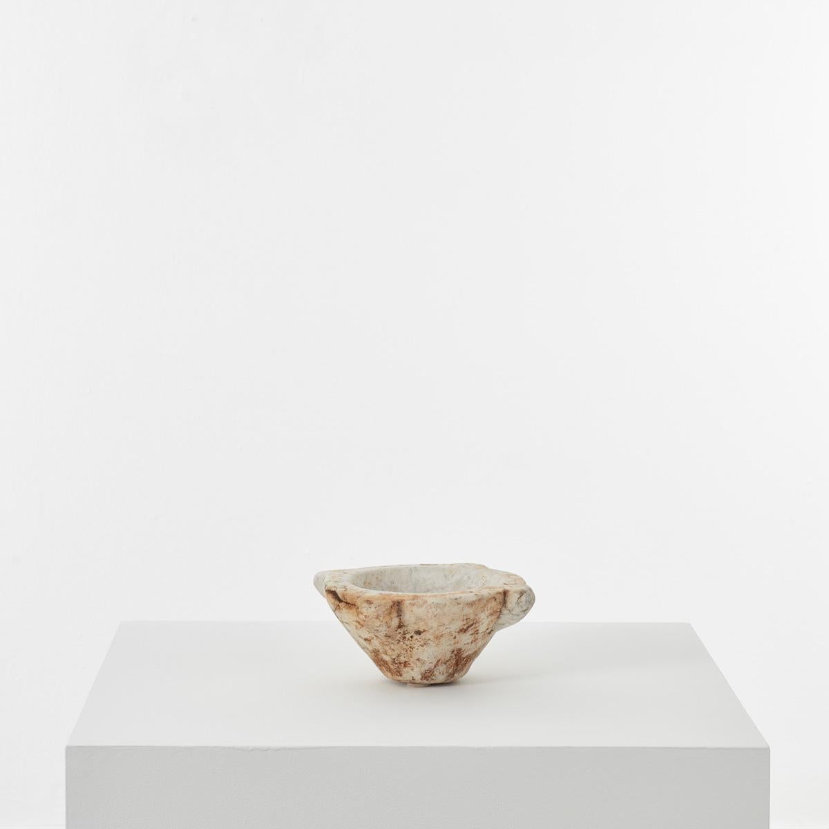 This ancient marble mortar has a rather mysterious aura about it. It is hand-sculpted from a single piece of stone, with beautiful ageing over time. Perhaps the most distinctive element of this piece is the chisel marks apparent on close inspection.