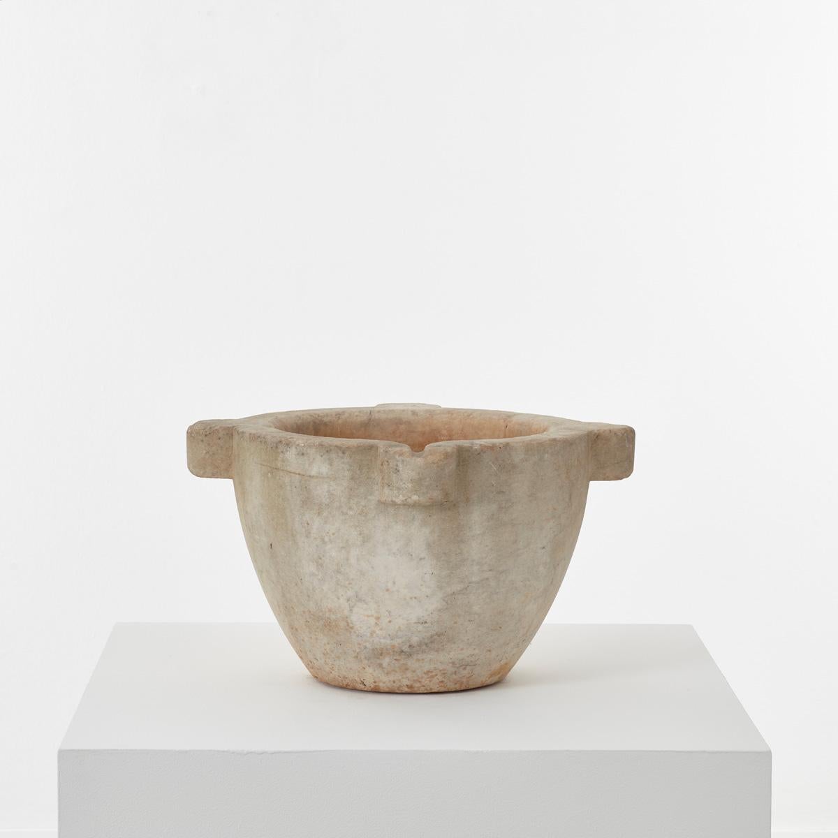 This 19th century marble mortar has a rather mysterious aura about it. It is hand-sculpted from a single piece of stone, with beautiful ageing over time. Perhaps the most distinctive element of this piece is the chisel marks apparent on close