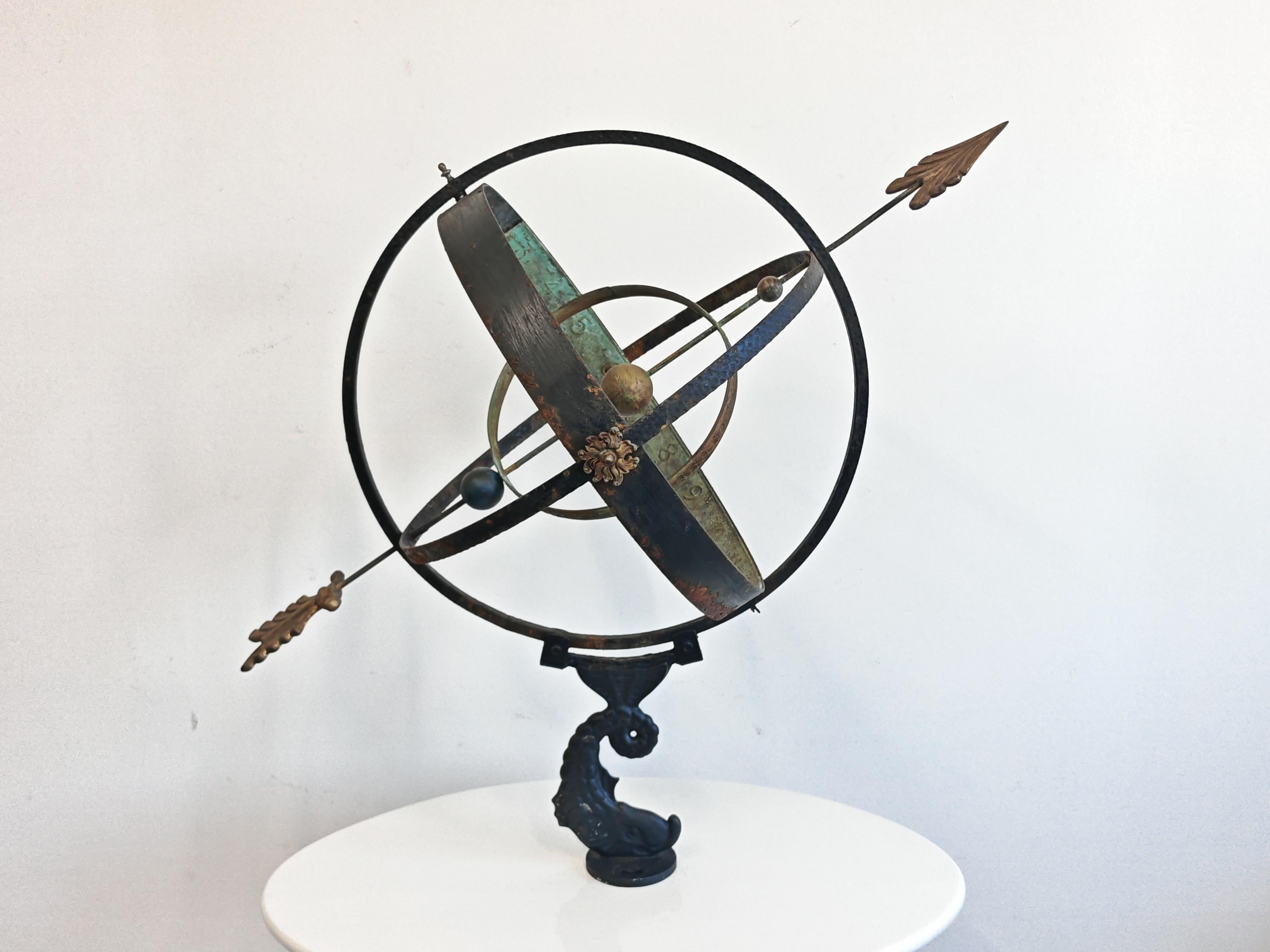 In this listing you will find a spectacular extra large Antique Sundial or Armillary Sphere with an arrow functioning as a gnomon. This type of item is commonly found as a garden ornament or indoor decor piece and is made of cast iron, and bronze