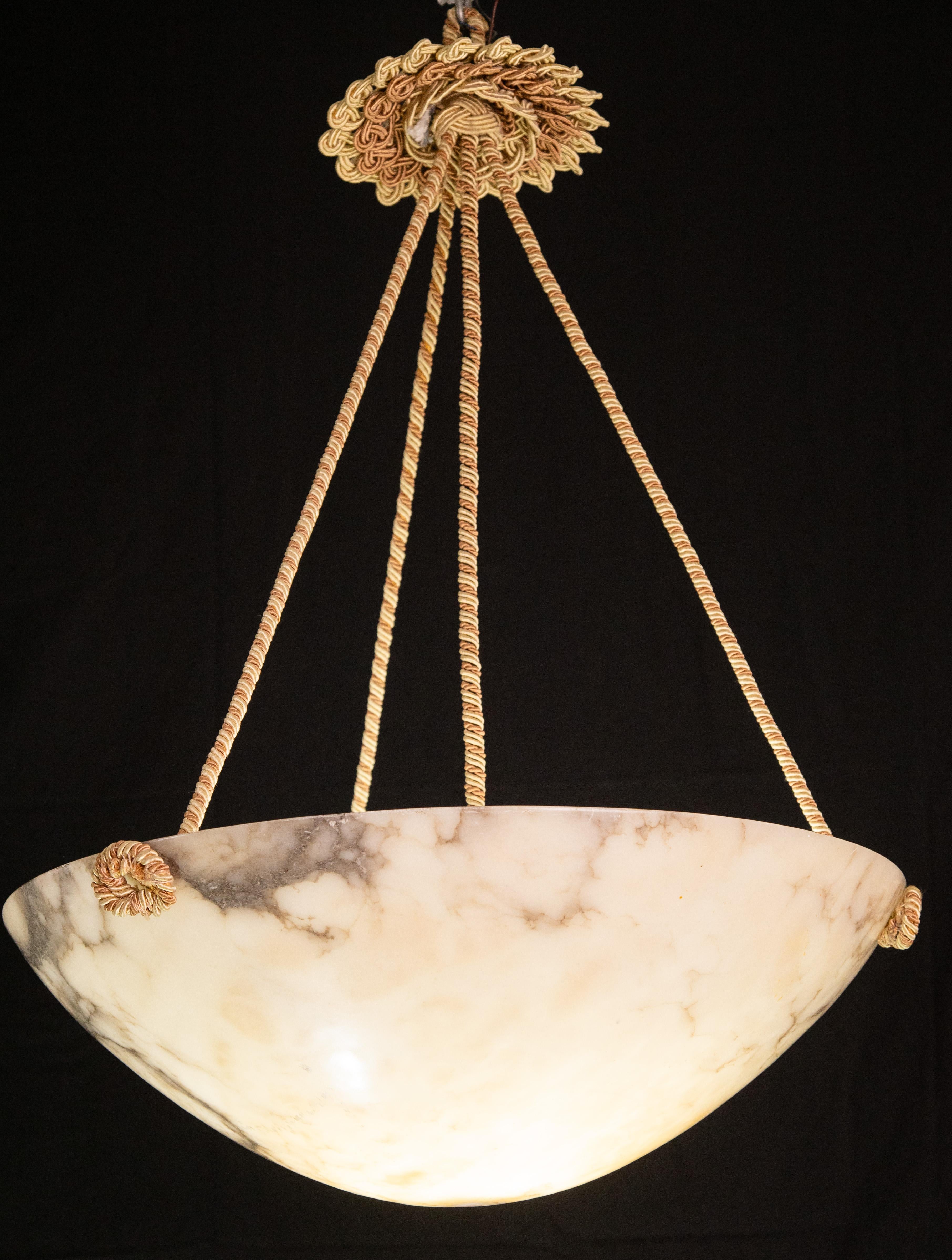 Extraordinary Antique white alabaster hanging chandelier in Art Deco style, circa 1950s, extremely rare because of its large diameter.
A unique piece in white alabaster, beautifully worked with shades and reflections of other colors when lit, still