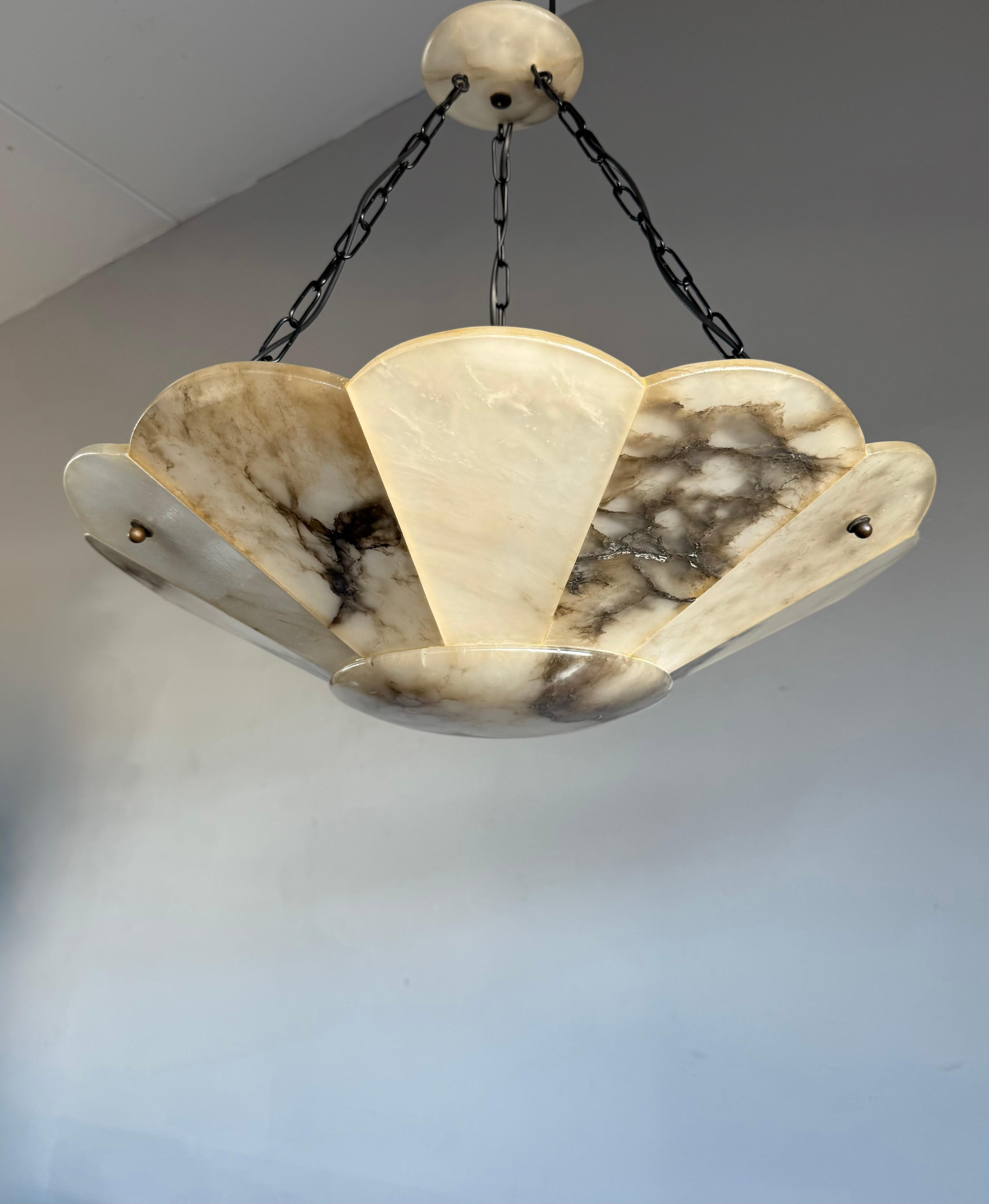 Lustre Art Déco de grande classe avec un grand abat-jour en forme de fleur stylisée ( 21.4 pouces Ø ) et un baldaquin parfait.

Grâce à sa grande taille et à son bon état, ce lustre en albâtre illuminera aussi bien vos journées que vos soirées. Il