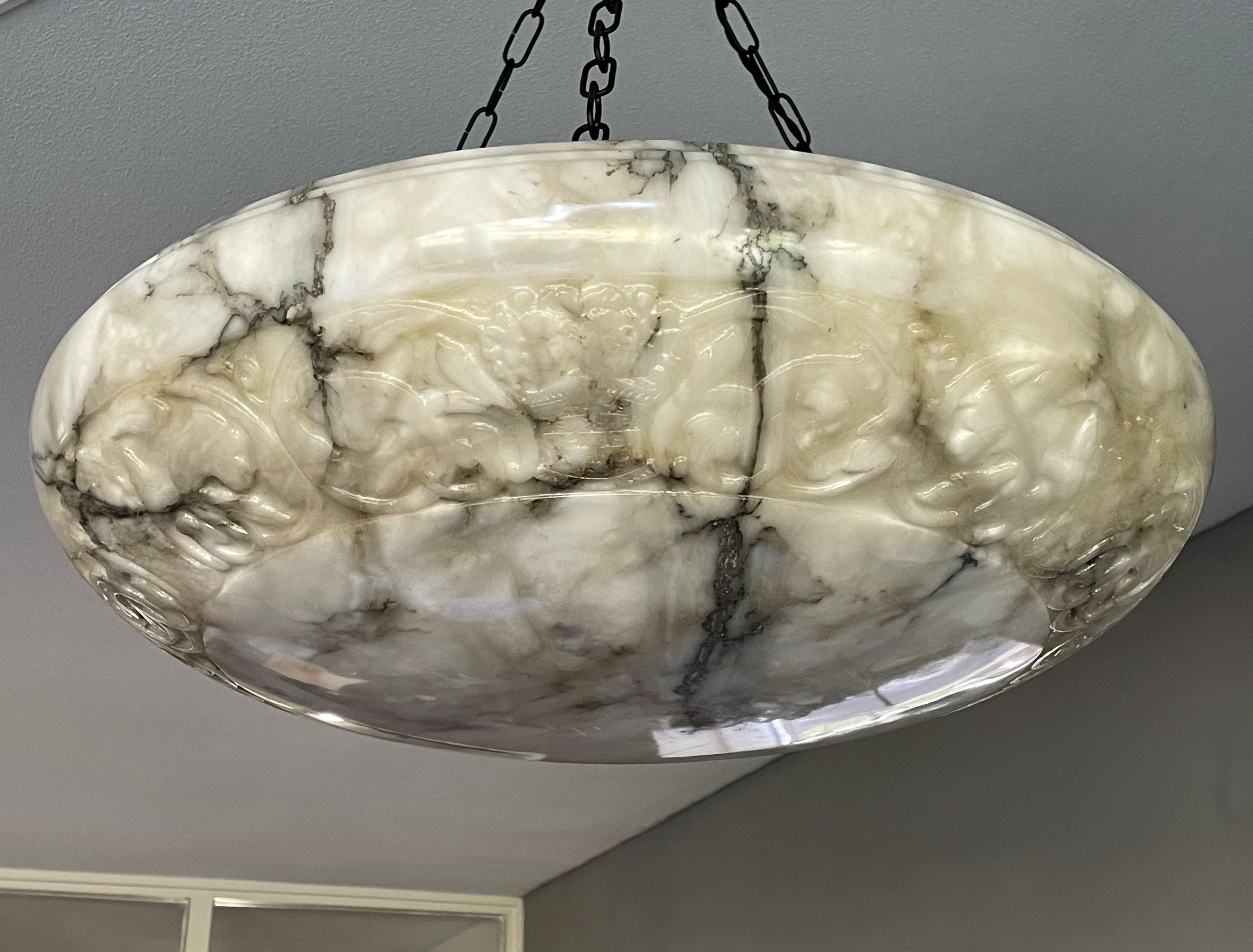Super size and great design, hand carved, antique alabaster chandelier.

Thanks to its large size and timeless dish design, this remarkable alabaster chandelier is the perfect lighting solution for many types of rooms and interiors and it too will