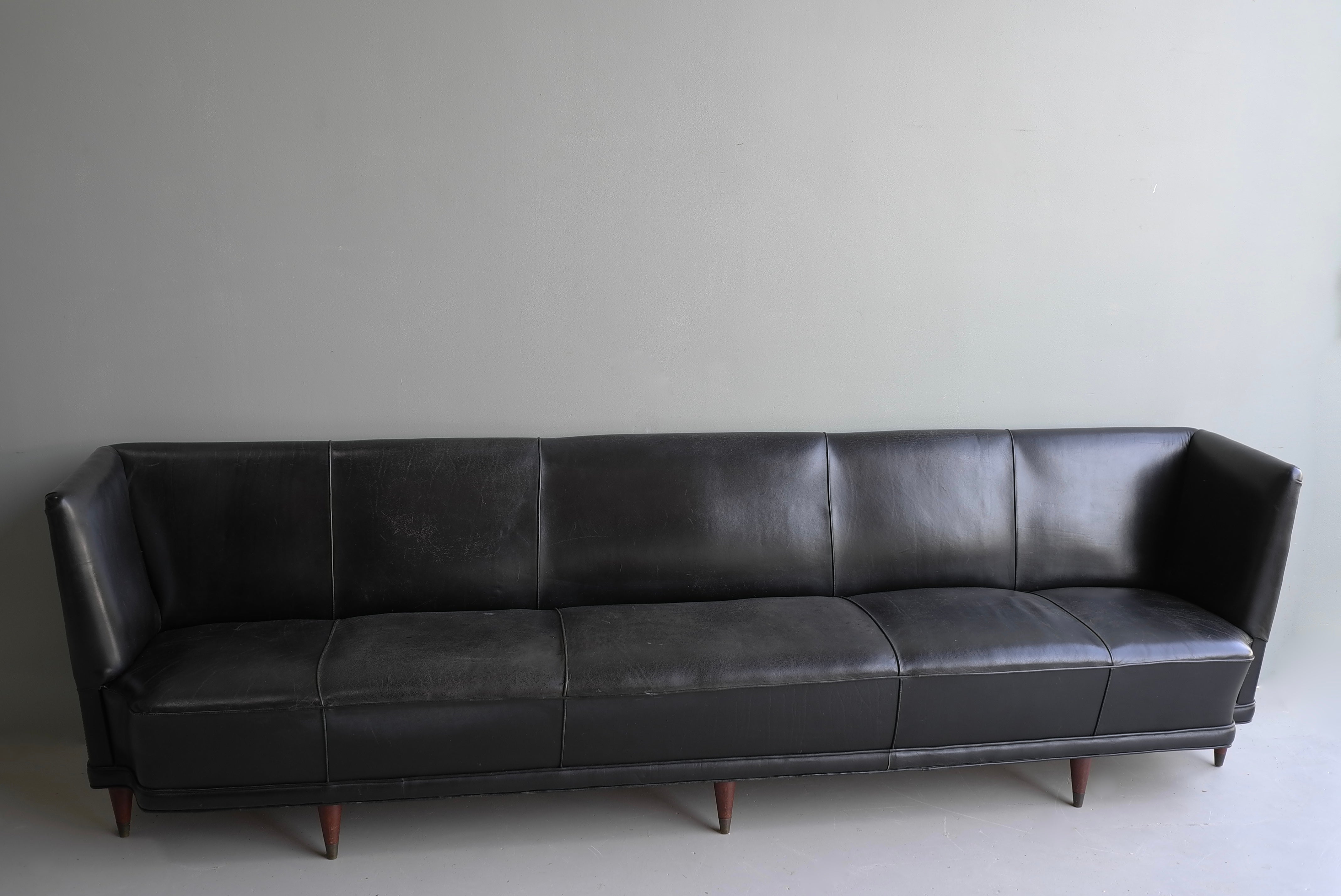 Extra large black leather cabinet maker Italian sofa 1950's.

The sofa was ordered from Italy by a famous Dutch Bank late 1950's.
It was a special order for the large entrance hall that needed wideness furniture.
This large high quality sofa has
