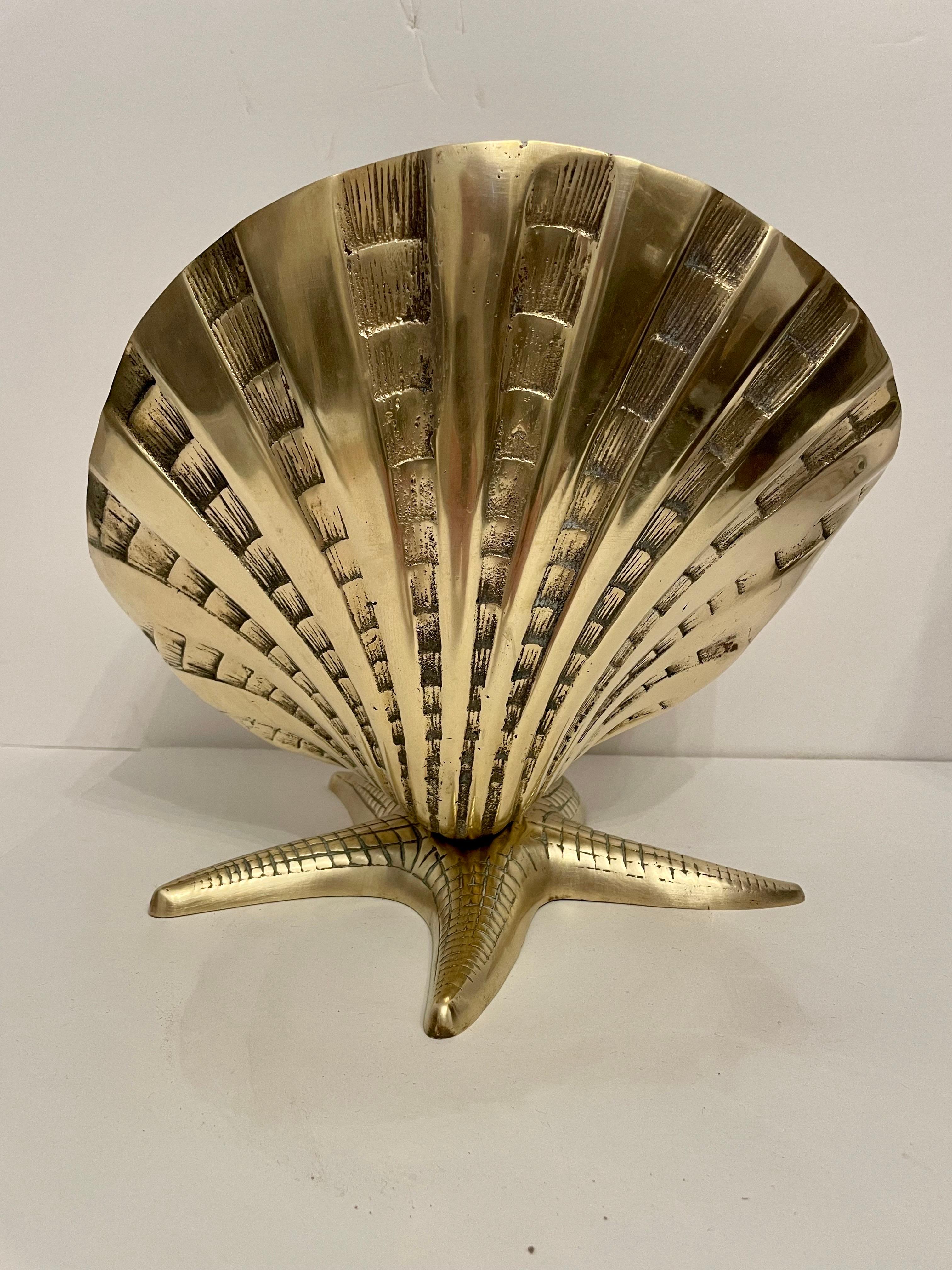Very large brass sea shell on star fish base. Hand polished. Nice statement piece. Very unusual design with nice detail. Overall nice condition. Ready for your beach house! Can be boxed and shipped.

 Extra Large Brass Sea Shell on Star Fish Base, a