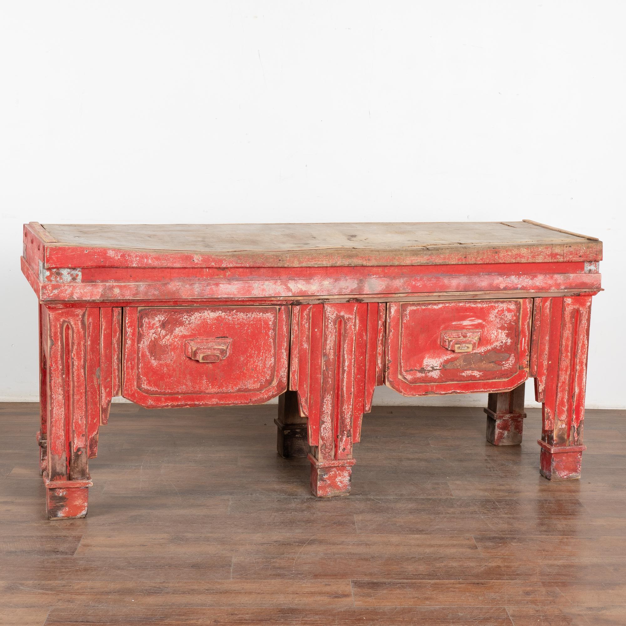Extra large French butcher's block table with heavily worn top and original red painted base with two deep, large drawers.
Loaded with character, notice the uneven wear, multiple gouges, scratches, dings, cracks, stains and gaps/separation that all