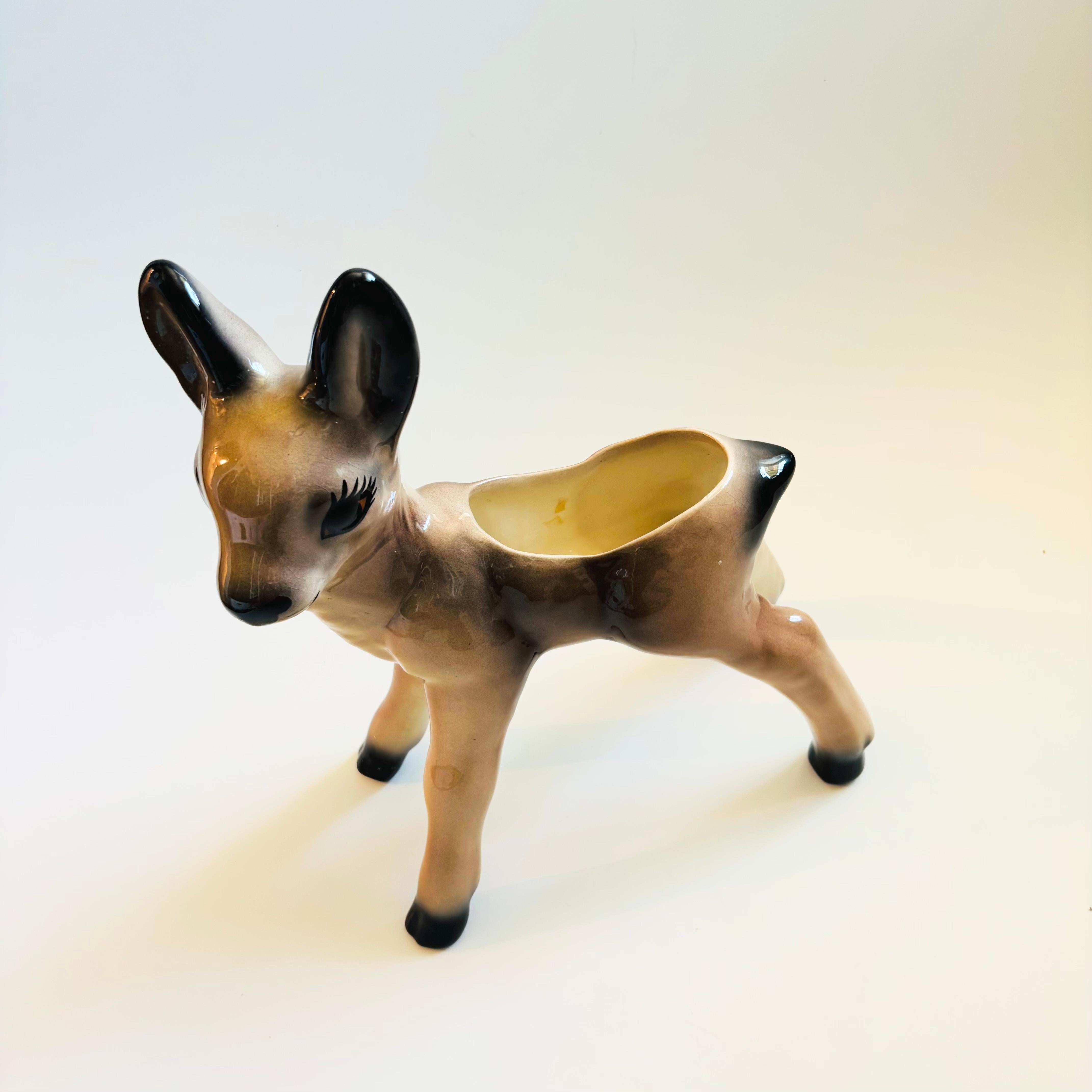 An extra large vintage ceramic deer planter. Lovely natural colors to the glaze with a roomy interior for a medium sized plant.

